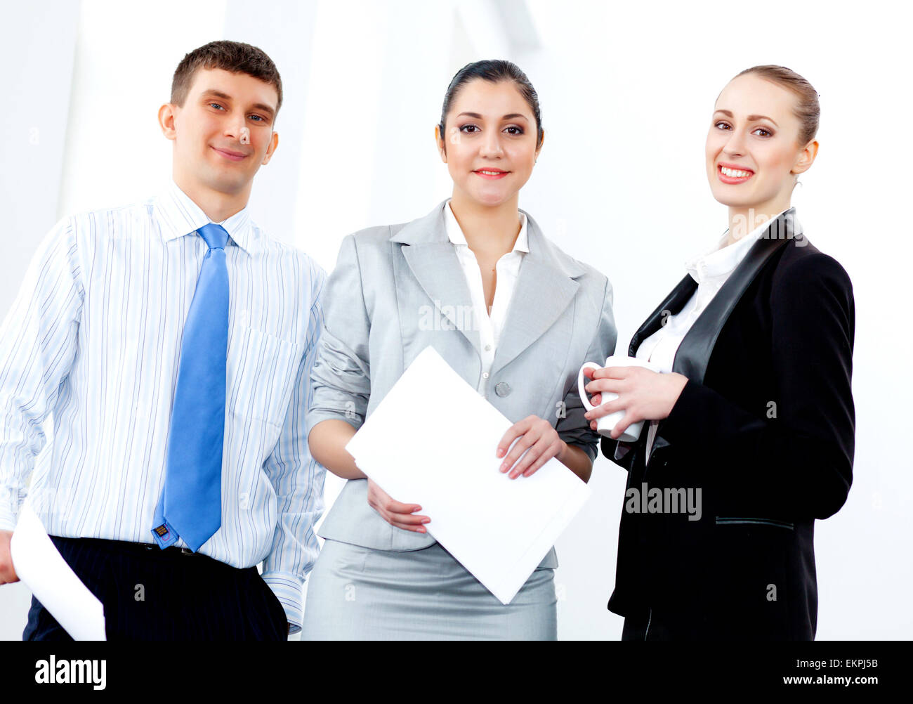 Three young business people laughing Stock Photo - Alamy