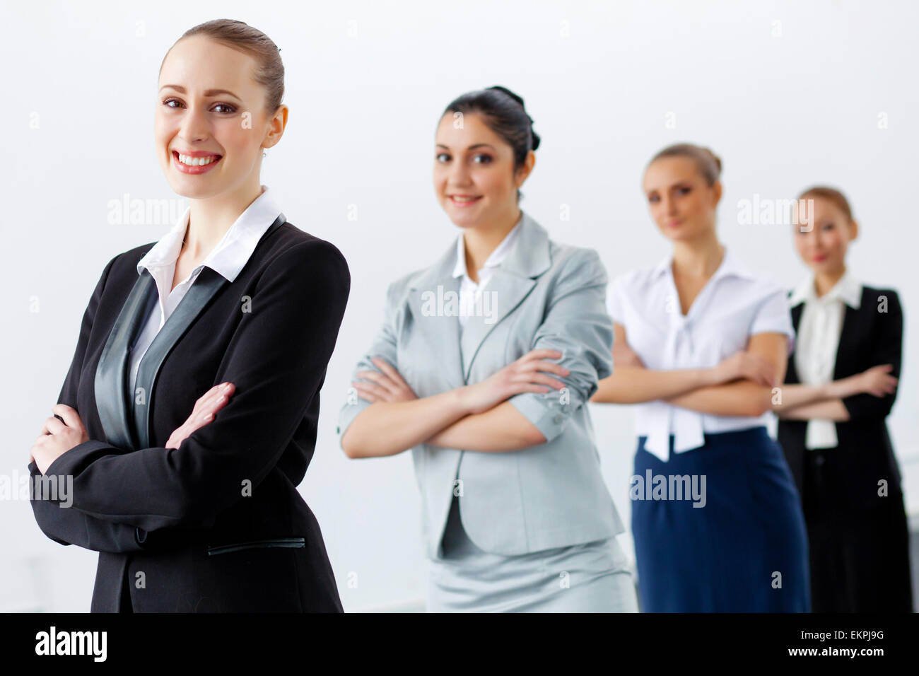 Four businesswomen standing in row Stock Photo - Alamy