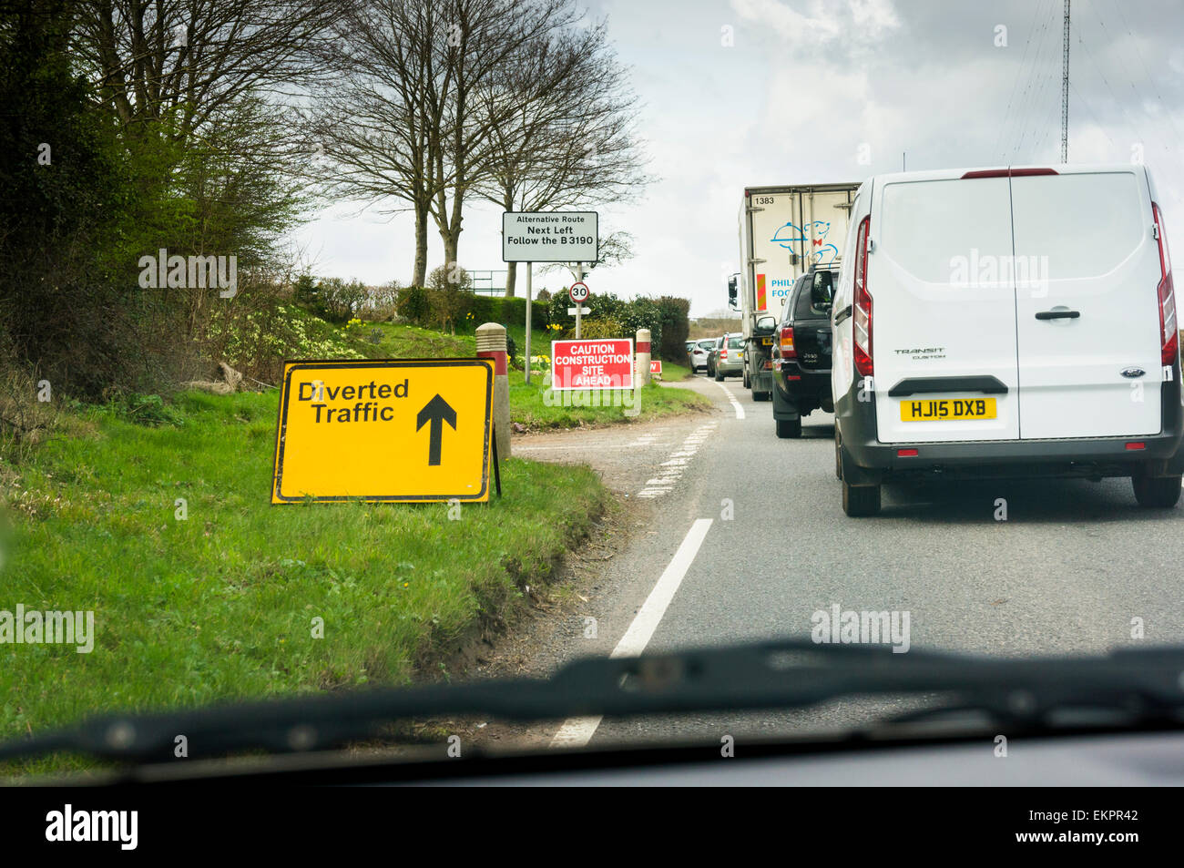 Traffic jam on a country road with diverted traffic sign at road works, England, UK Stock Photo
