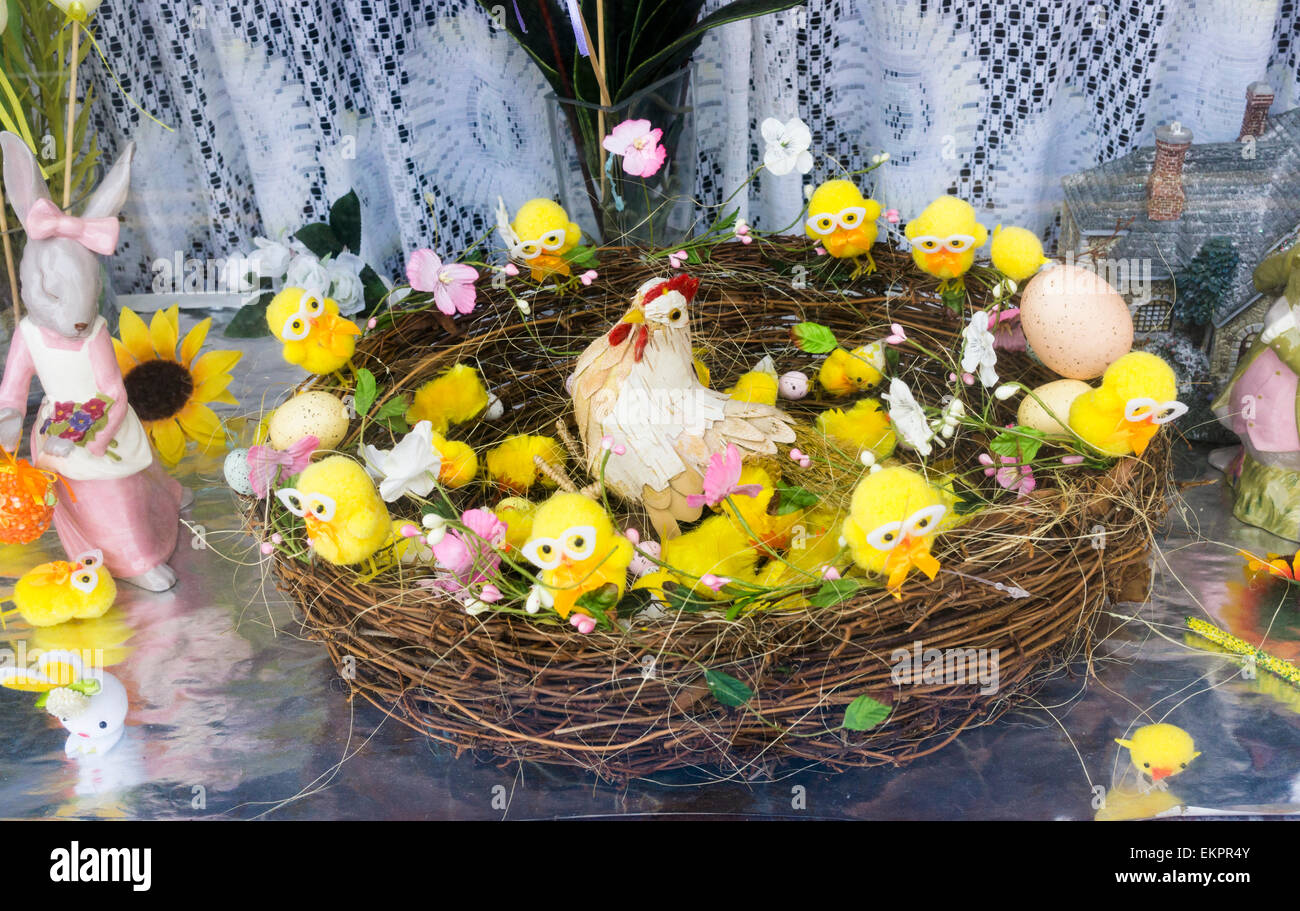 Easter basket display with chicks and bunny in a cafe window, England, UK Stock Photo