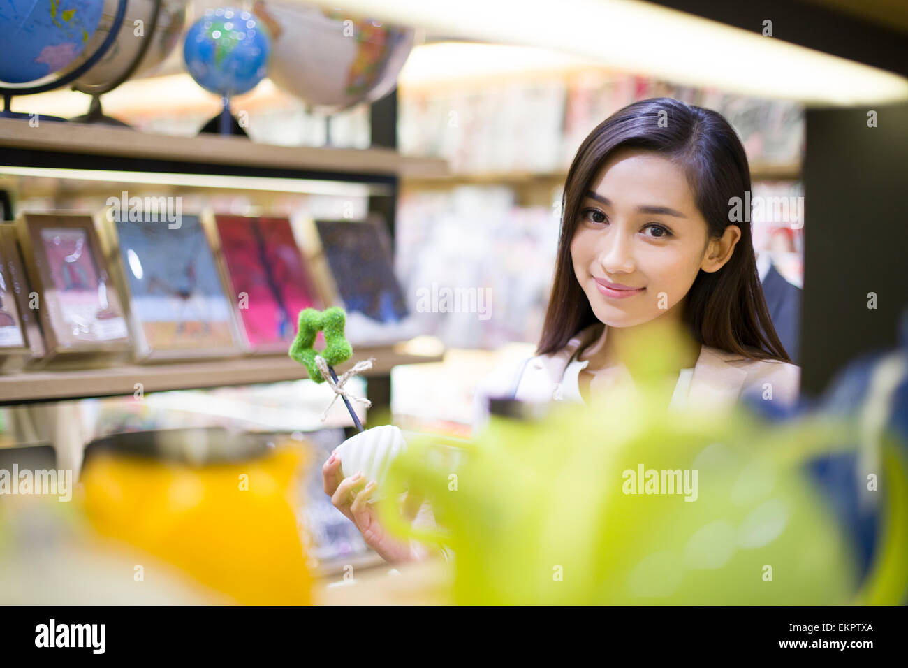 Young woman buying souvenirs in gift shop Stock Photo - Alamy