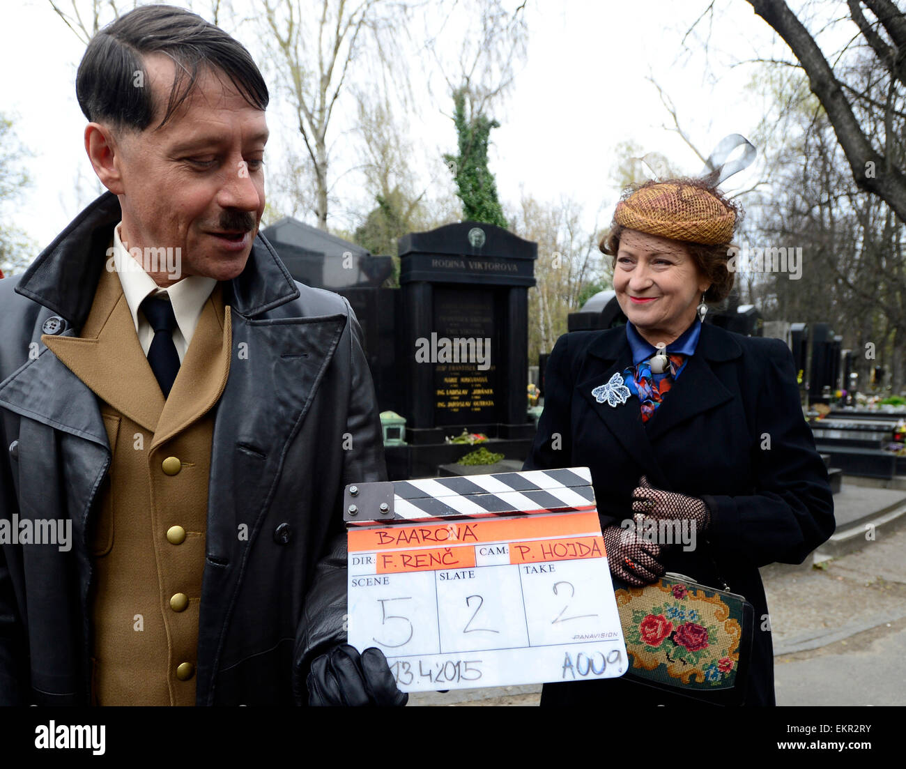 Shooting of the film about Czechoslovak film star Lida Baarova starts in the Olsany cemetary, Prague, Czech Republic, April 13, 2015. Pictured from left: Pavel Kriz and Simona Stasova. The lead role in the prepared Czech film about actress Baarova, who was mistress of Nazi Germany´s Propaganda Minister Joseph Goebbels before the war, will play Slovak actress Tana Pauhofova. Stock Photo