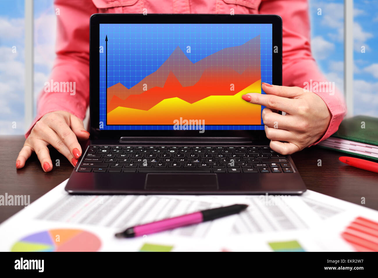 businesswoman pointing to laptop with forex chart Stock Photo