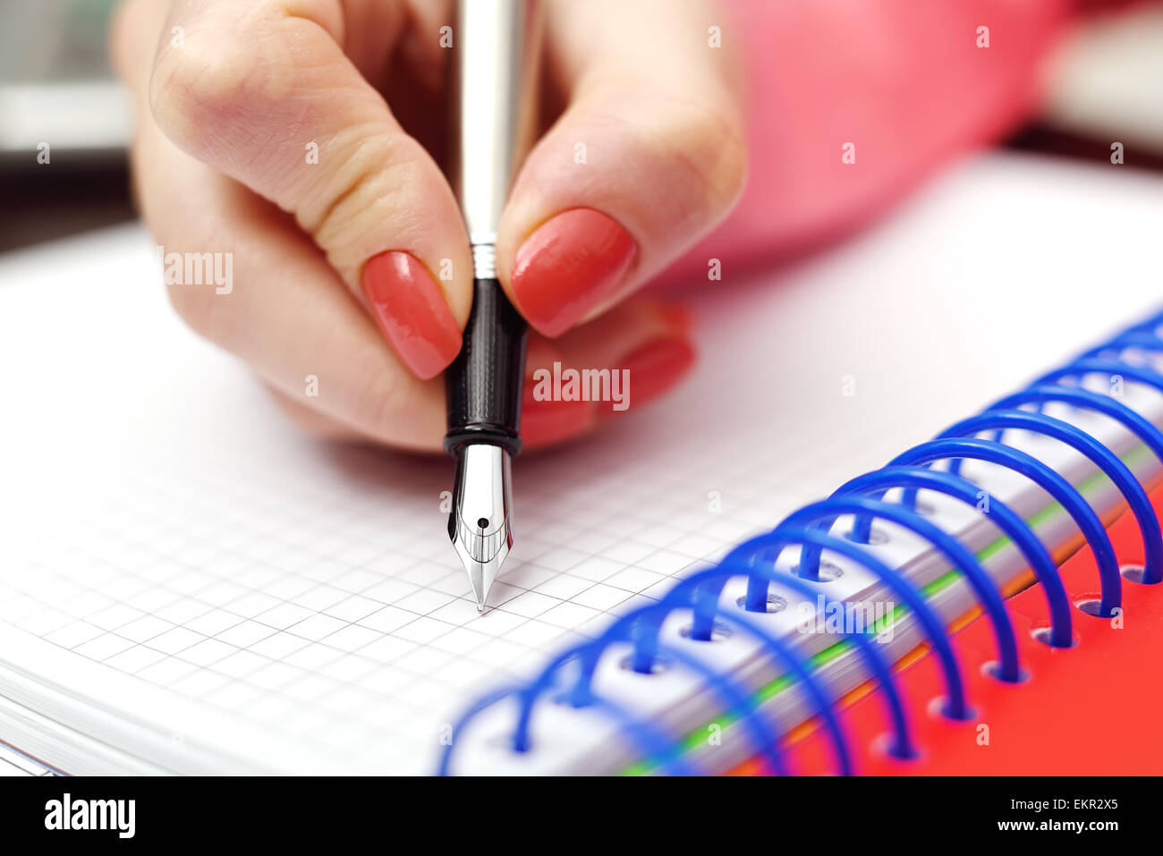 Female hand with ink pen writing in notebook Stock Photo - Alamy