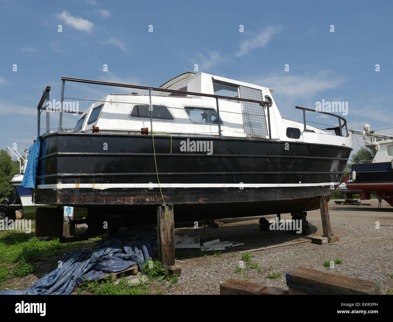 exterior of an old steel hulled boat in process of being stripped down and repaired and refurbished as a project Stock Photo
