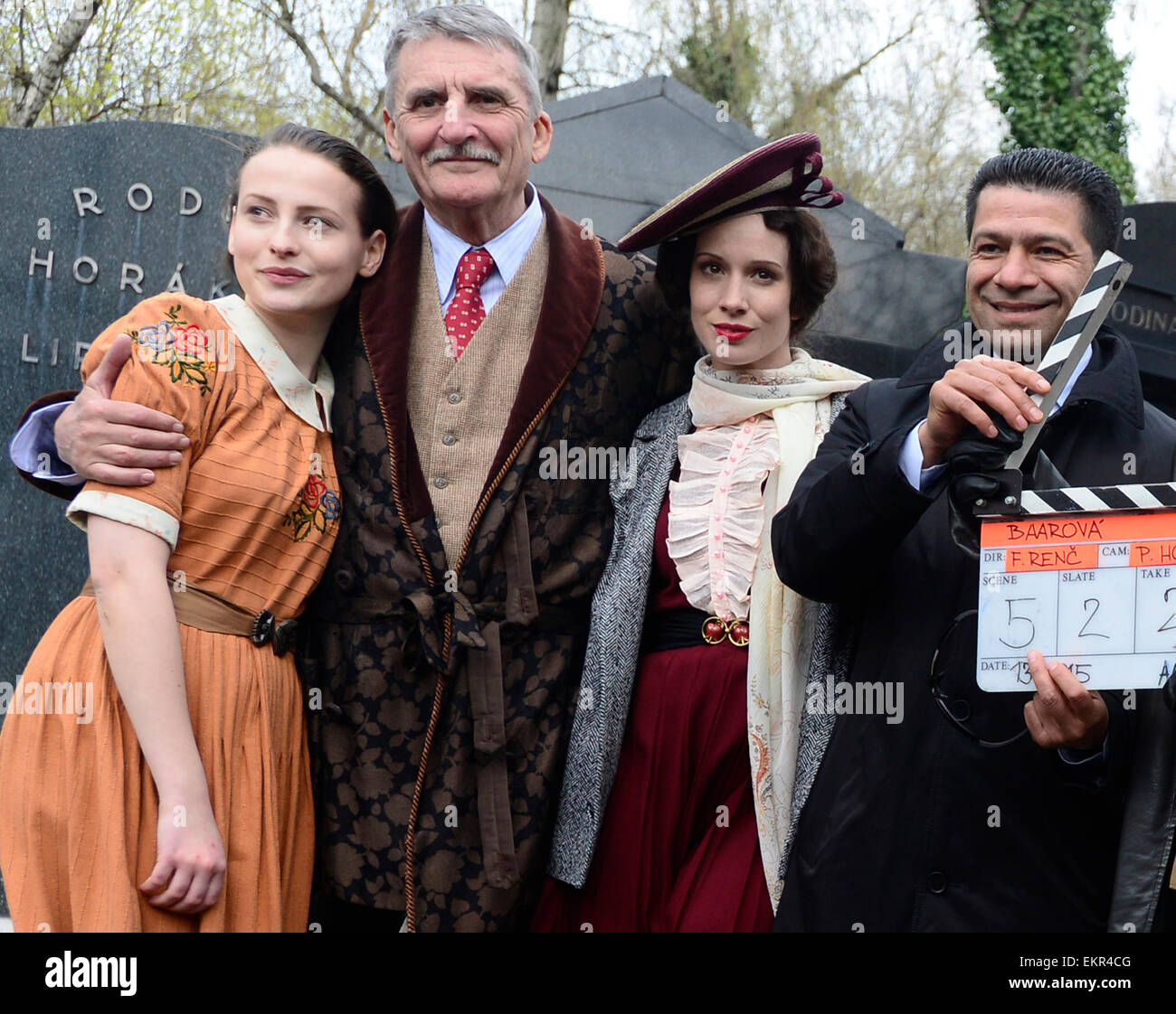 Shooting of the film about Czechoslovak film star Lida Baarova starts in the Olsany cemetary, Prague, Czech Republic, April 13, 2015. Pictured from left: Anna Fialova, Martin Huba, Tana Pauhofova and Karen Mchitarjan. The lead role in the prepared Czech film about actress Baarova, who was mistress of Nazi Germany´s Propaganda Minister Joseph Goebbels before the war, will play Slovak actress Tana Pauhofova. Austrian actor Karl Markovics will play Goebbels, while one of the most famous German actors, Gedeon Burkhard, was cast for the role of actor Gustav Froehlich, who was Baarova´s partner both Stock Photo