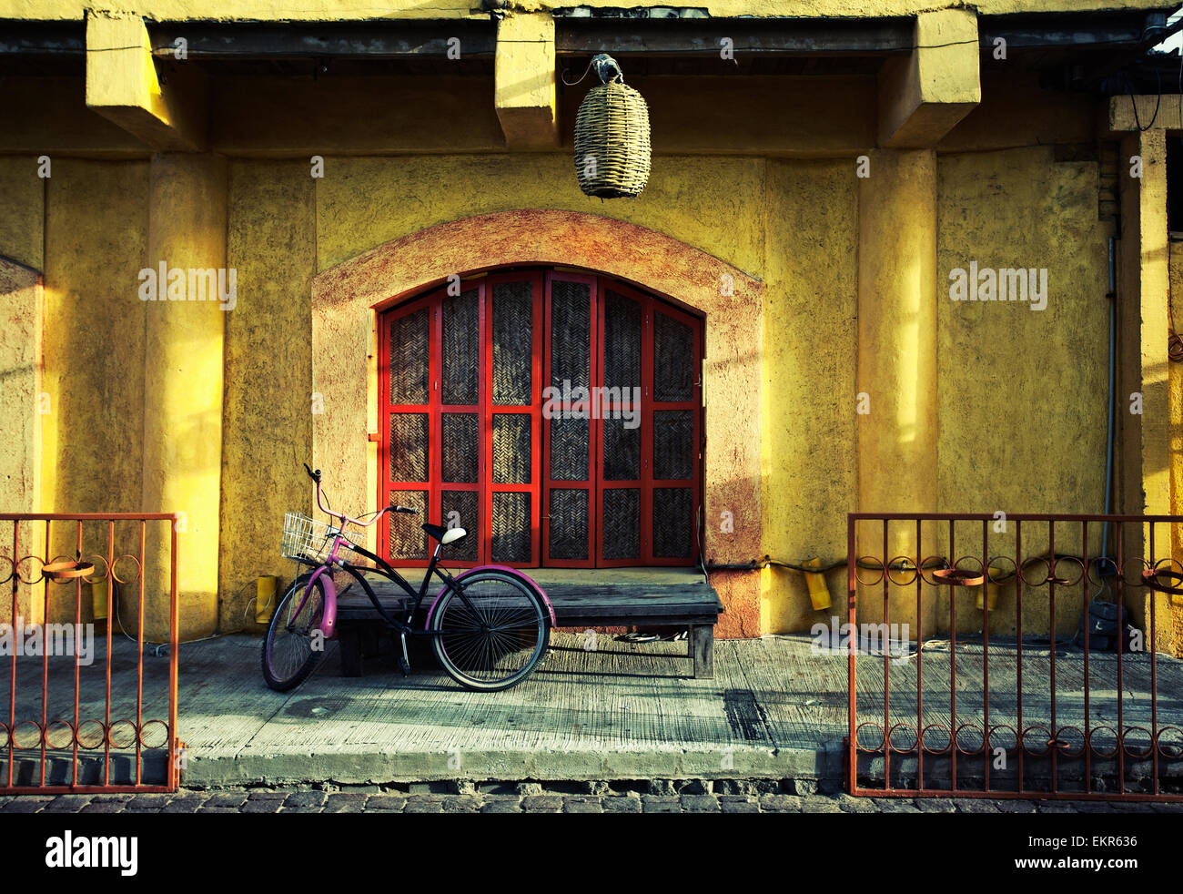 A bicycle parked outside the door of a cafe in a Mexican town. Stock Photo