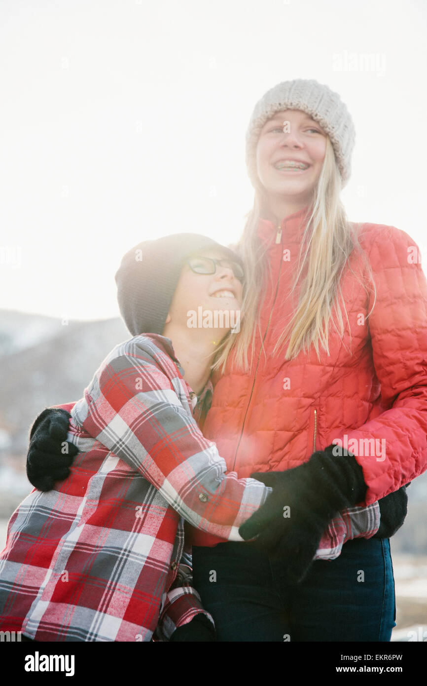 A brother and sister hugging each other. Stock Photo