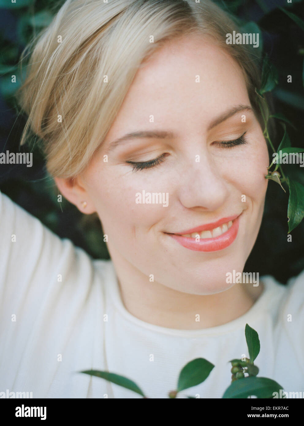 A pretty woman smiling with her eyes closed. Stock Photo