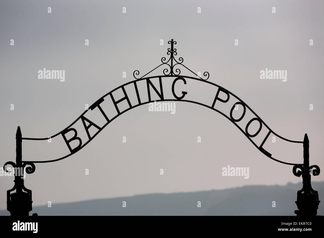 A metal arch over a gate to the Bathing Pool in a resort. Stock Photo