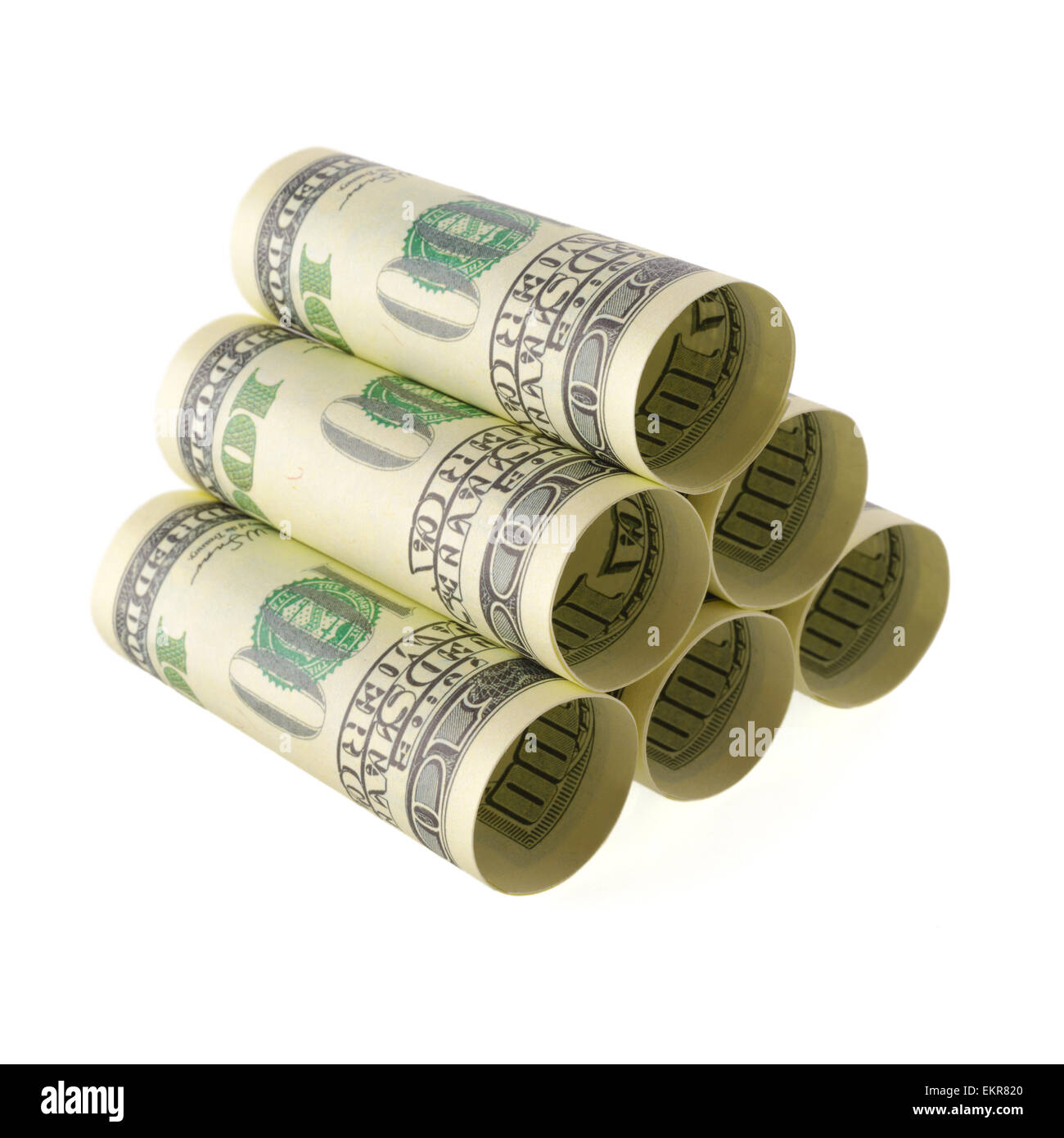 Isolated objects: financial concept, one-hundred dollar bills, rolled as tubes and piled, isolated on white background. Stock Photo