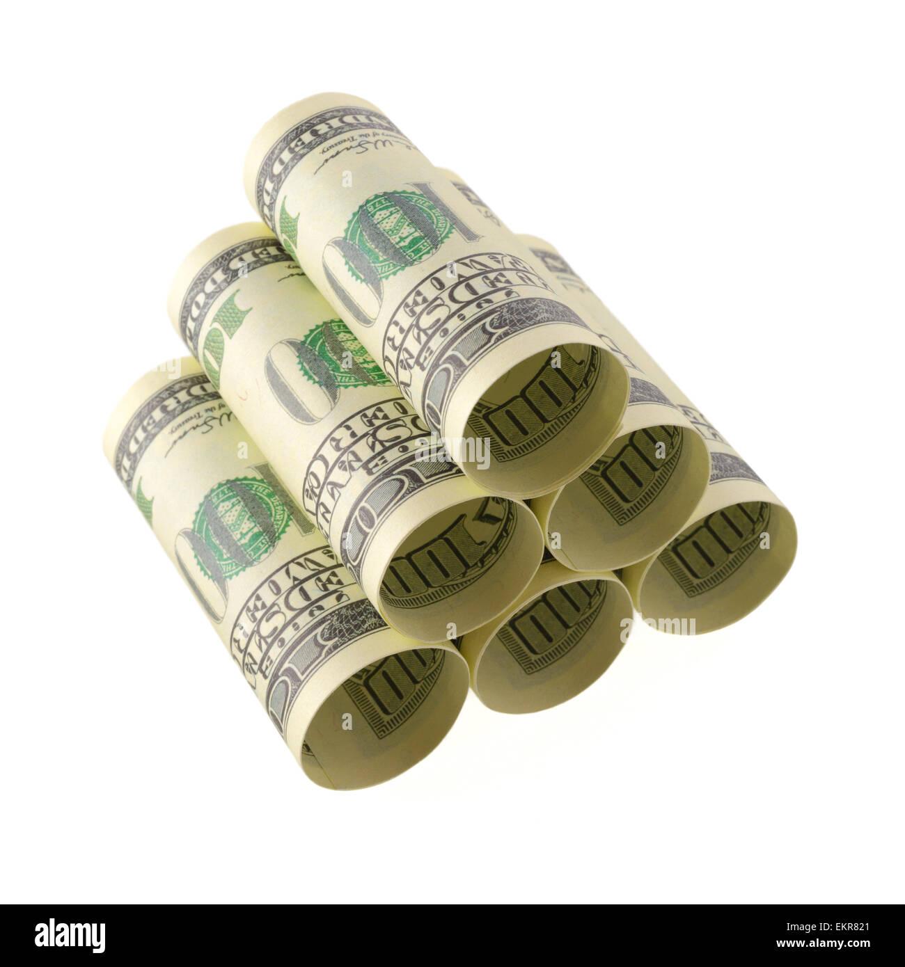 Isolated objects: financial concept, one-hundred dollar bills, rolled as tubes and piled, isolated on white background. Stock Photo