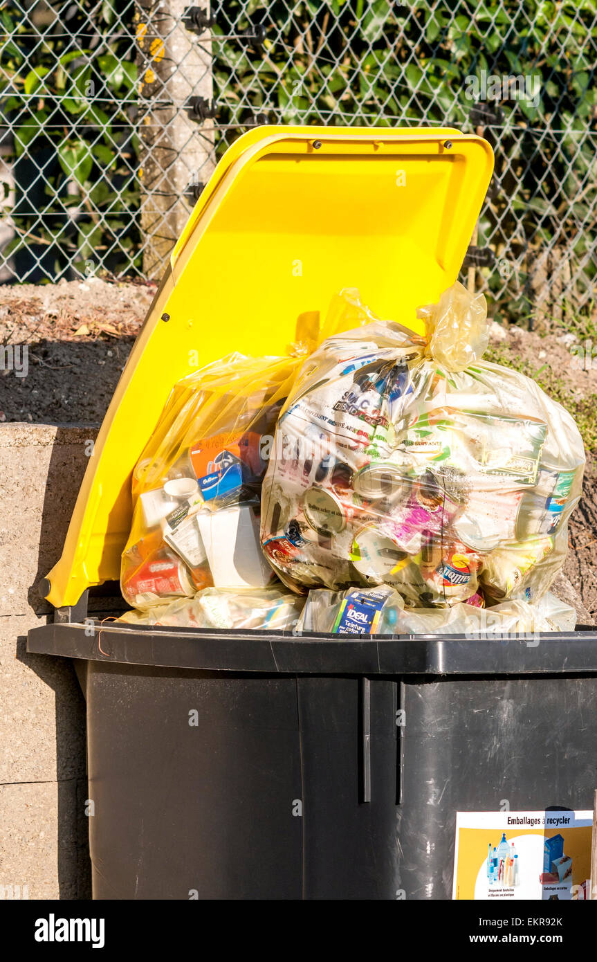 Council wheelie bin overflowing with recyclable rubbish - France. Stock Photo