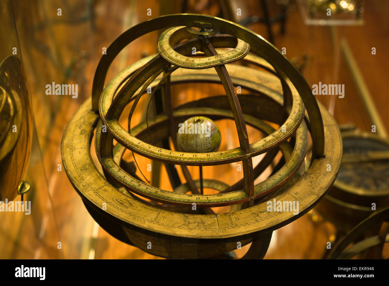 Antique brass armillary sphere on a wooden stand Stock Photo