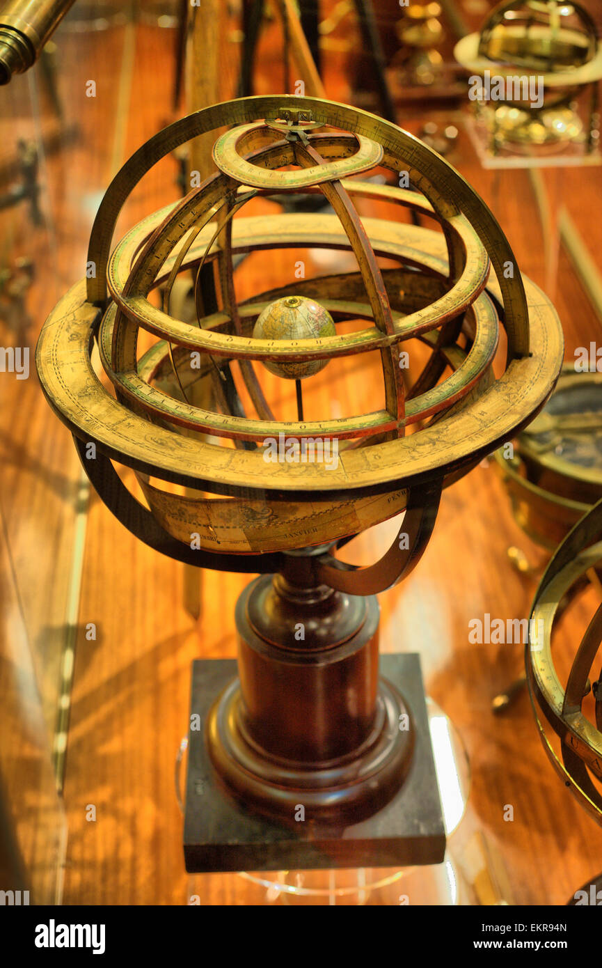 Antique brass armillary sphere on a wooden stand. HDR Stock Photo