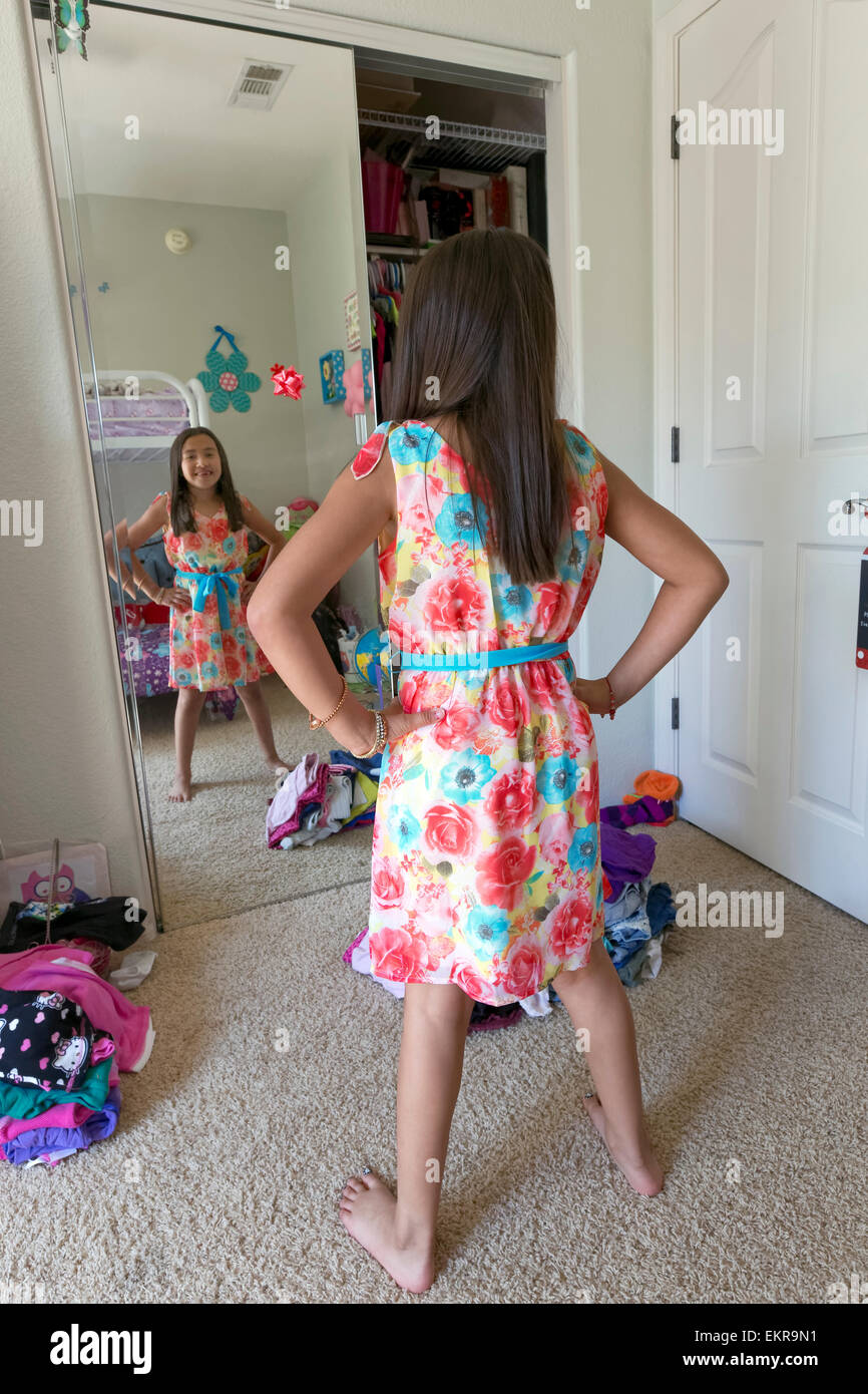 Young girl trying on clothes in her room at home Stock Photo