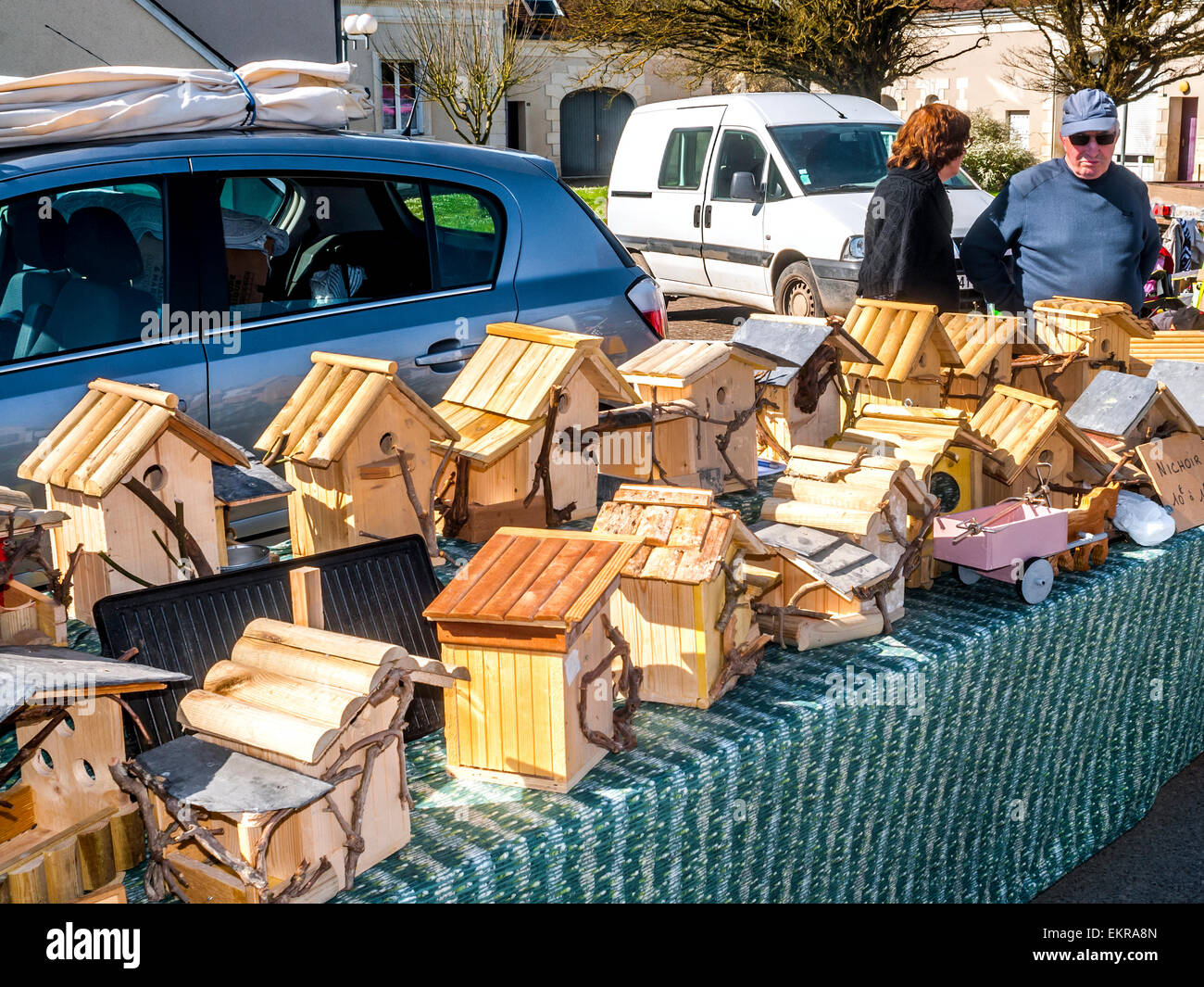 Hand-made wooden bird boxes and bird feeders at open-air fair - France. Stock Photo