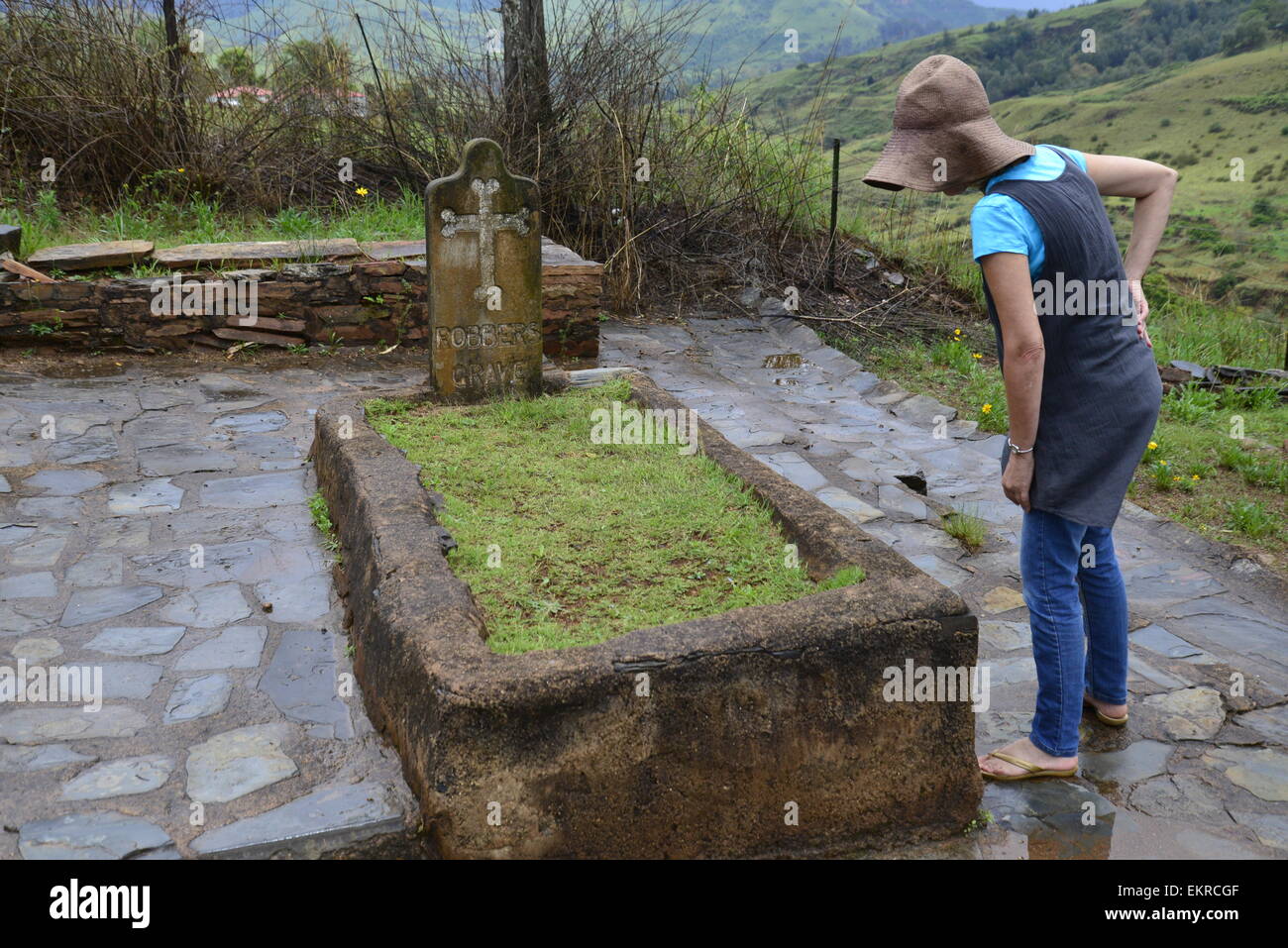 Pilgrimsrest -- historical mining town from the gold rush in 1890 in Mpumalanga province of South Africa. Woman with brown hat by robber's grave. Stock Photo