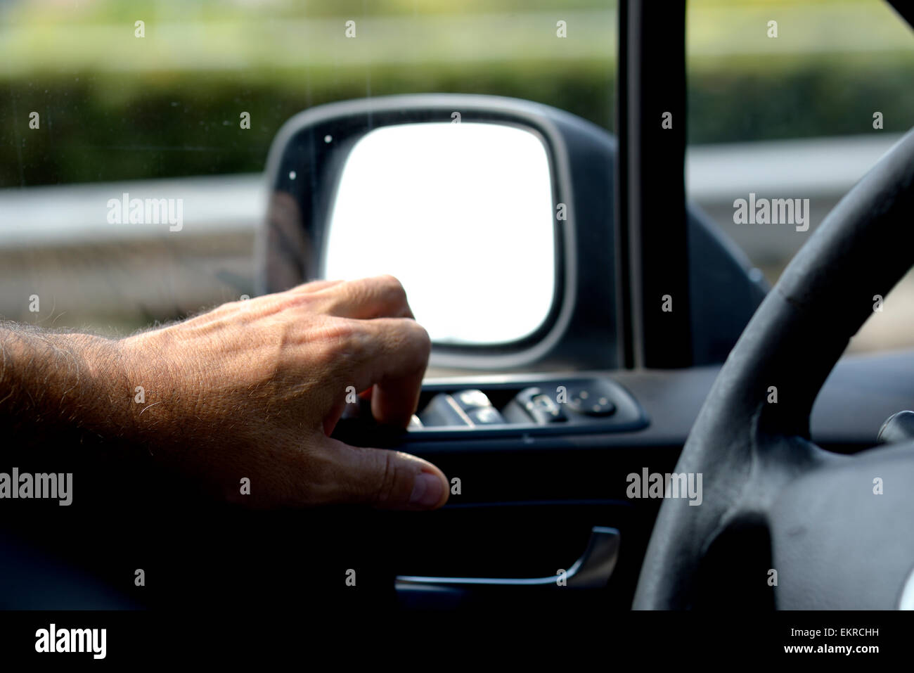 Hand and Rearview Mirror Stock Photo