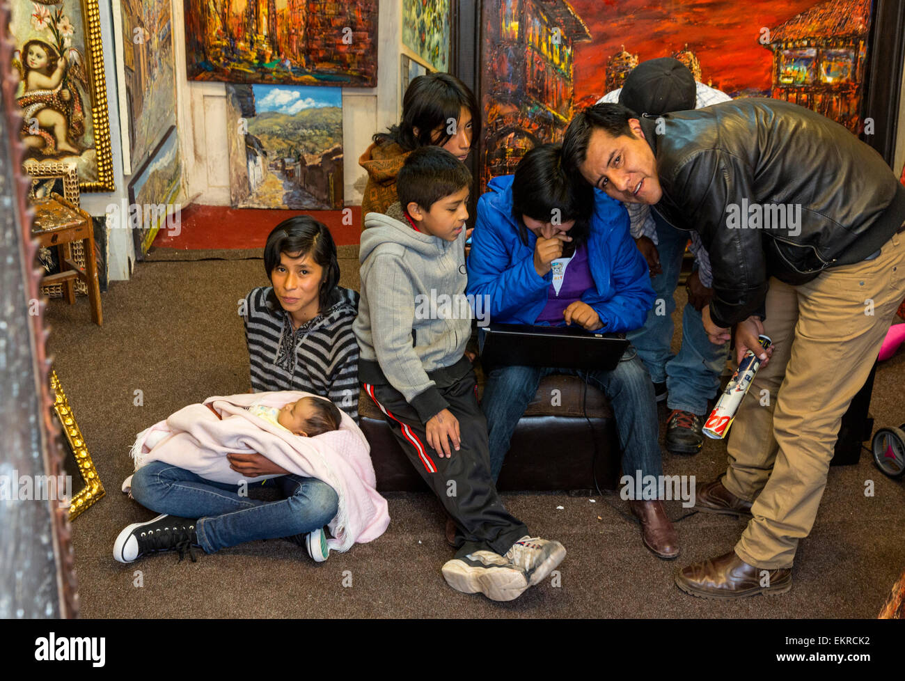 Peru, Cusco.  Family inside a Small Art Gallery Selling Local Artists' Works. Stock Photo