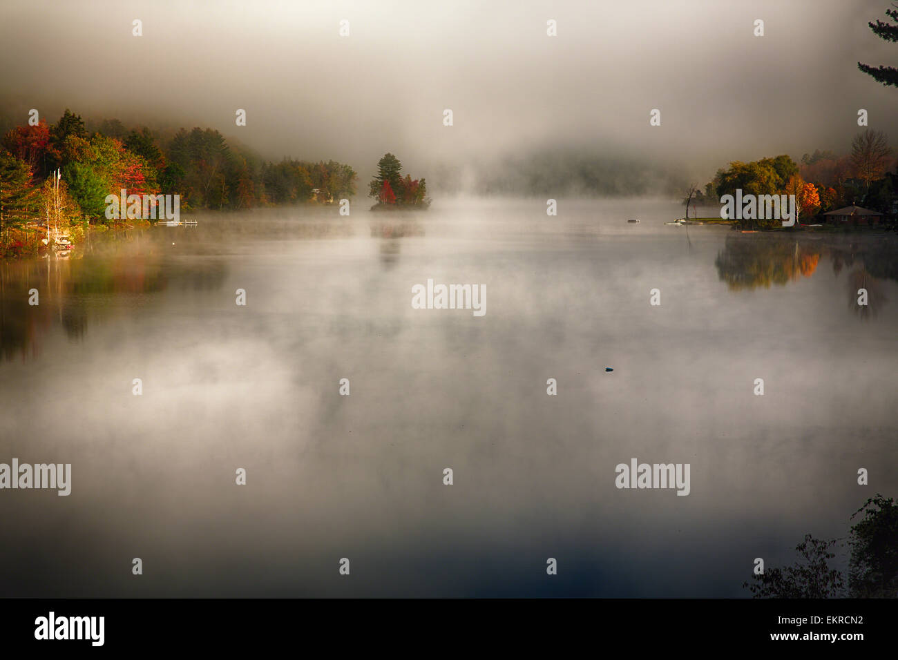 High Angle View of a Lake with Morning Fog During Fall, Knapp Brook Pond, Vermont Stock Photo