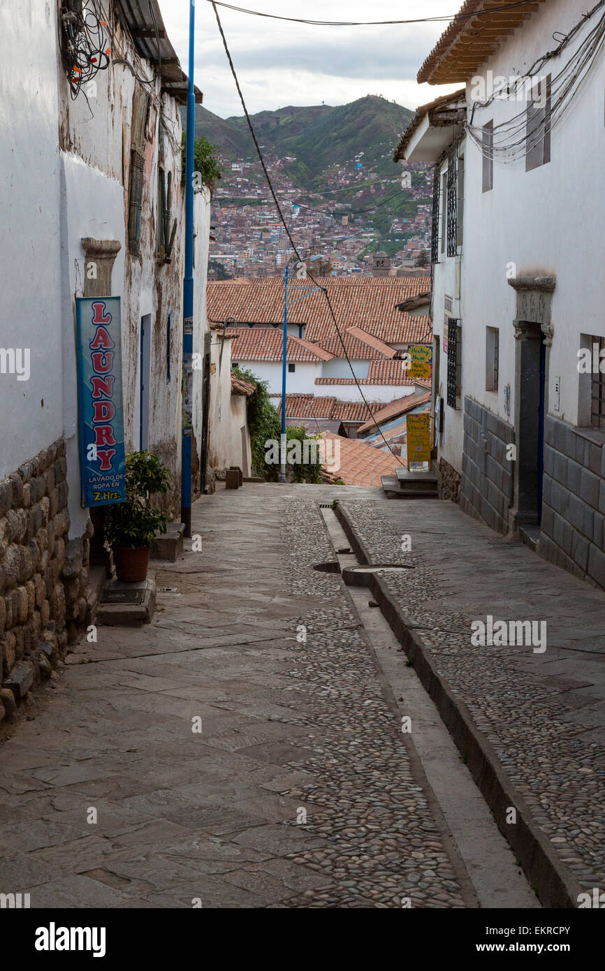 Peru, Cusco.  Street Scene Showing Traditional Inca Gutter in Middle of the Street, for Rainwater Run-off. Stock Photo