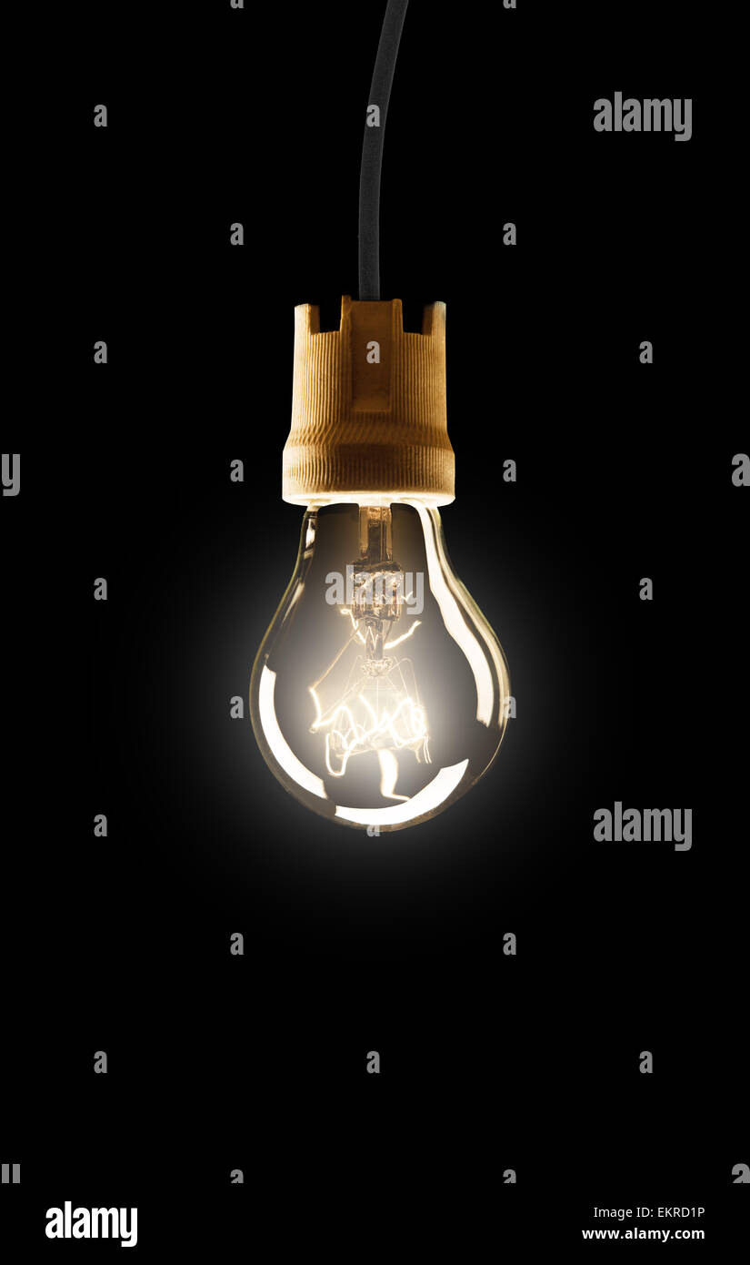 Light bulb hanging on wire, isolated on black background Stock Photo