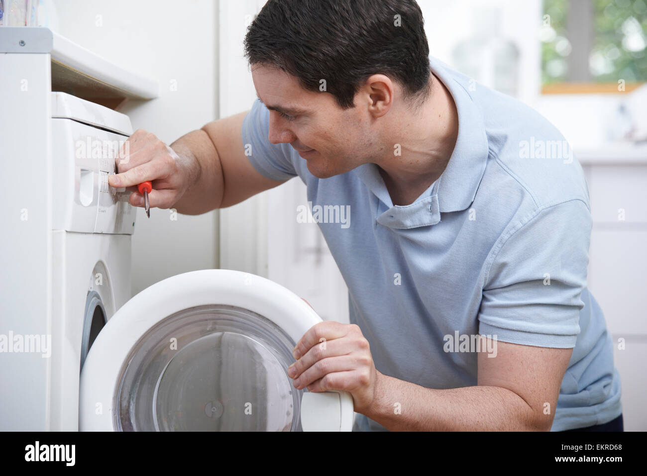 Engineer Mending Domestic Washing Machine Stock Photo