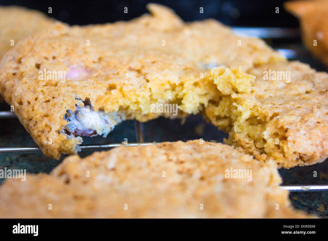 Home baked easter cookies with mini eggs inside on a cooking rack. Stock Photo