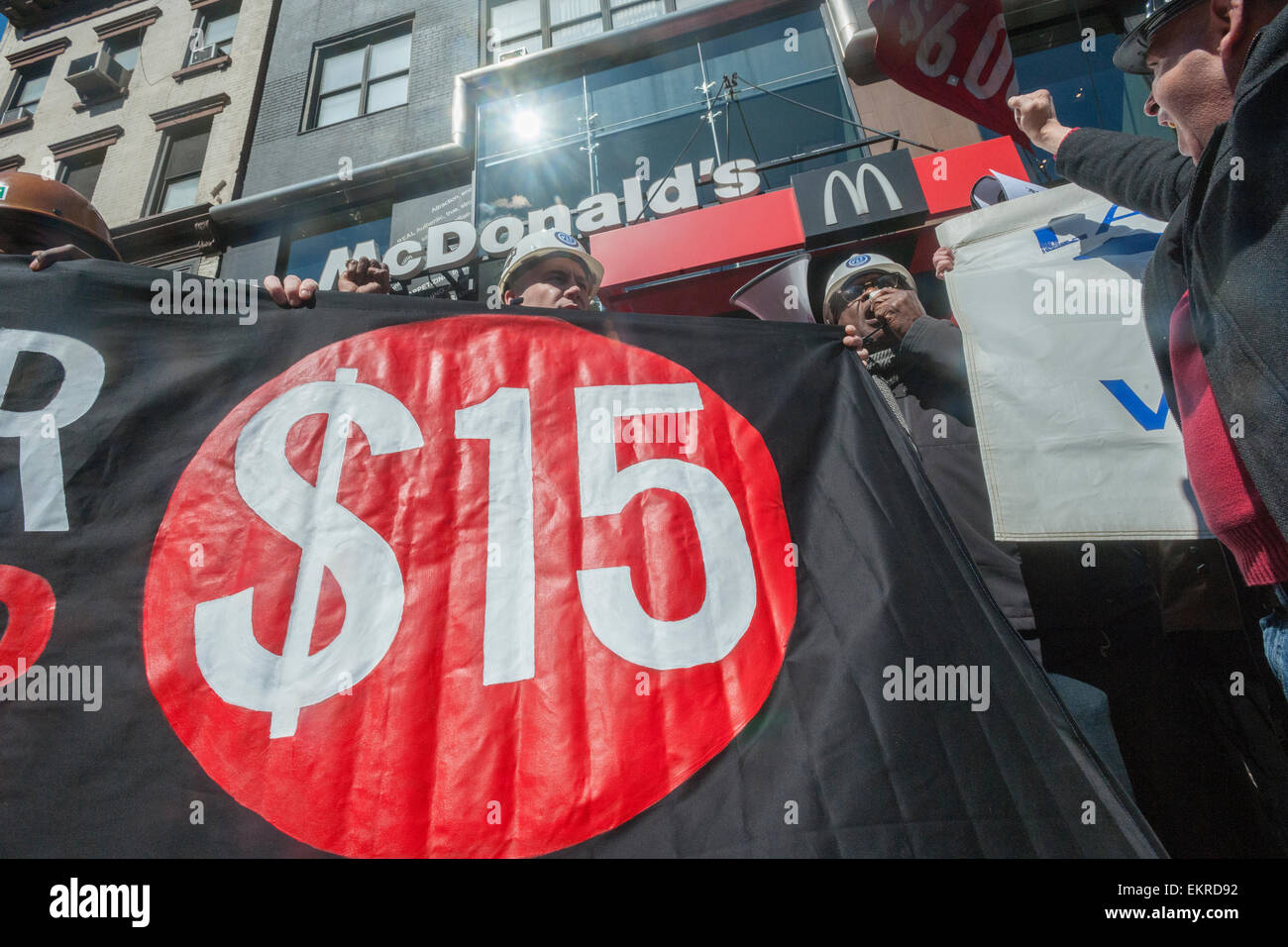 Construction workers join fast food workers at a protest in front of a McDonald's restaurant in New York on Saturday, April 4, 2015. The workers are advocating that fast food restaurants adopt a $15 per hour living wage for their employees. This is part of a series of events leading up to the National Day of Action on April 15 where workers in 200 cities will protest for wages, unions and better jobs. (© Richard B. Levine) Stock Photo