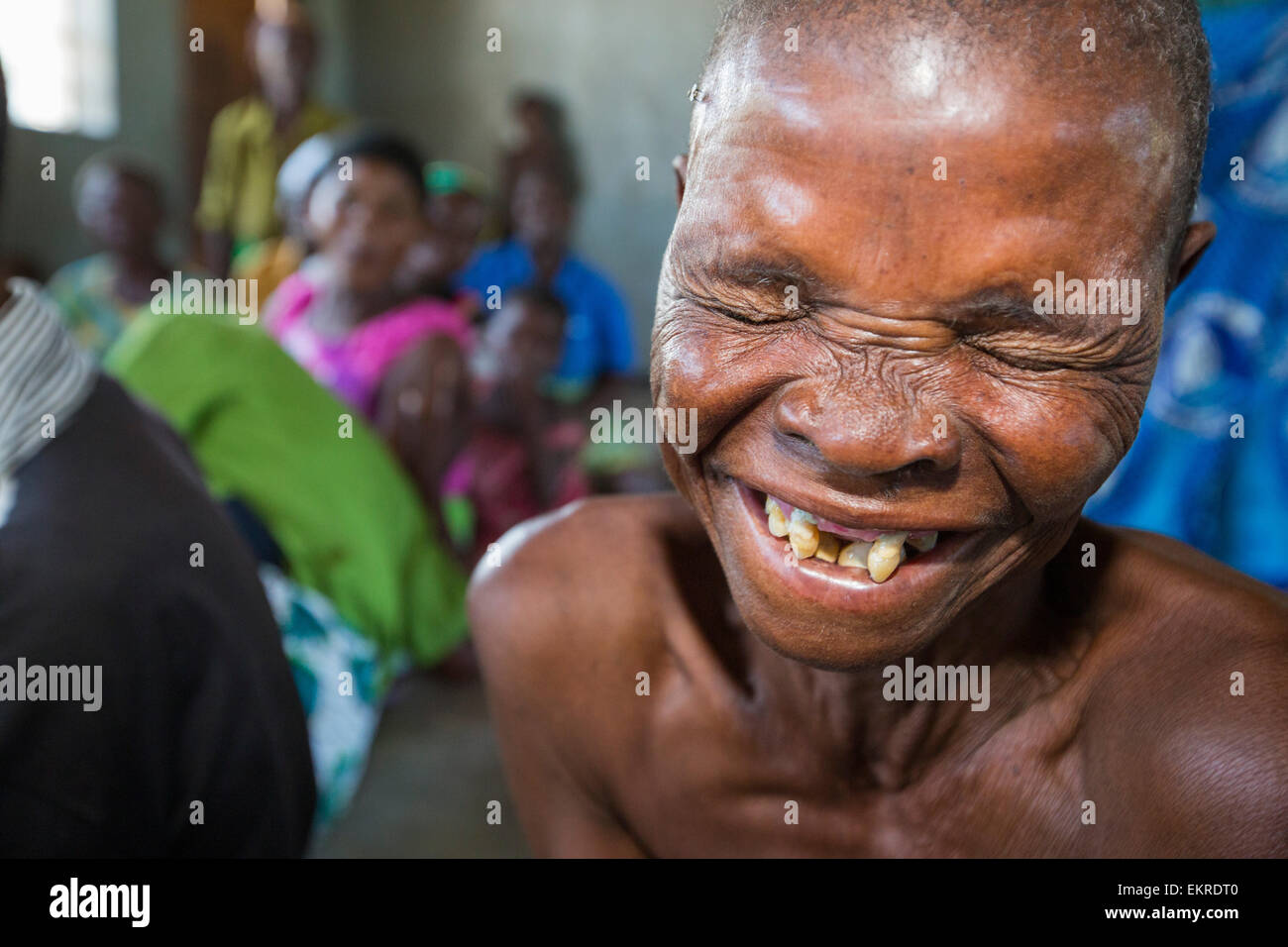 In mid January 2015, a three day period of excessive rain brought unprecedented floods to the small poor African country of Malawi. It displaced nearly quarter of a million people, devastated 64,000 hectares of land, and killed several hundred people. This shot shows an old woman in a refugee camp near Chikwawa. Stock Photo