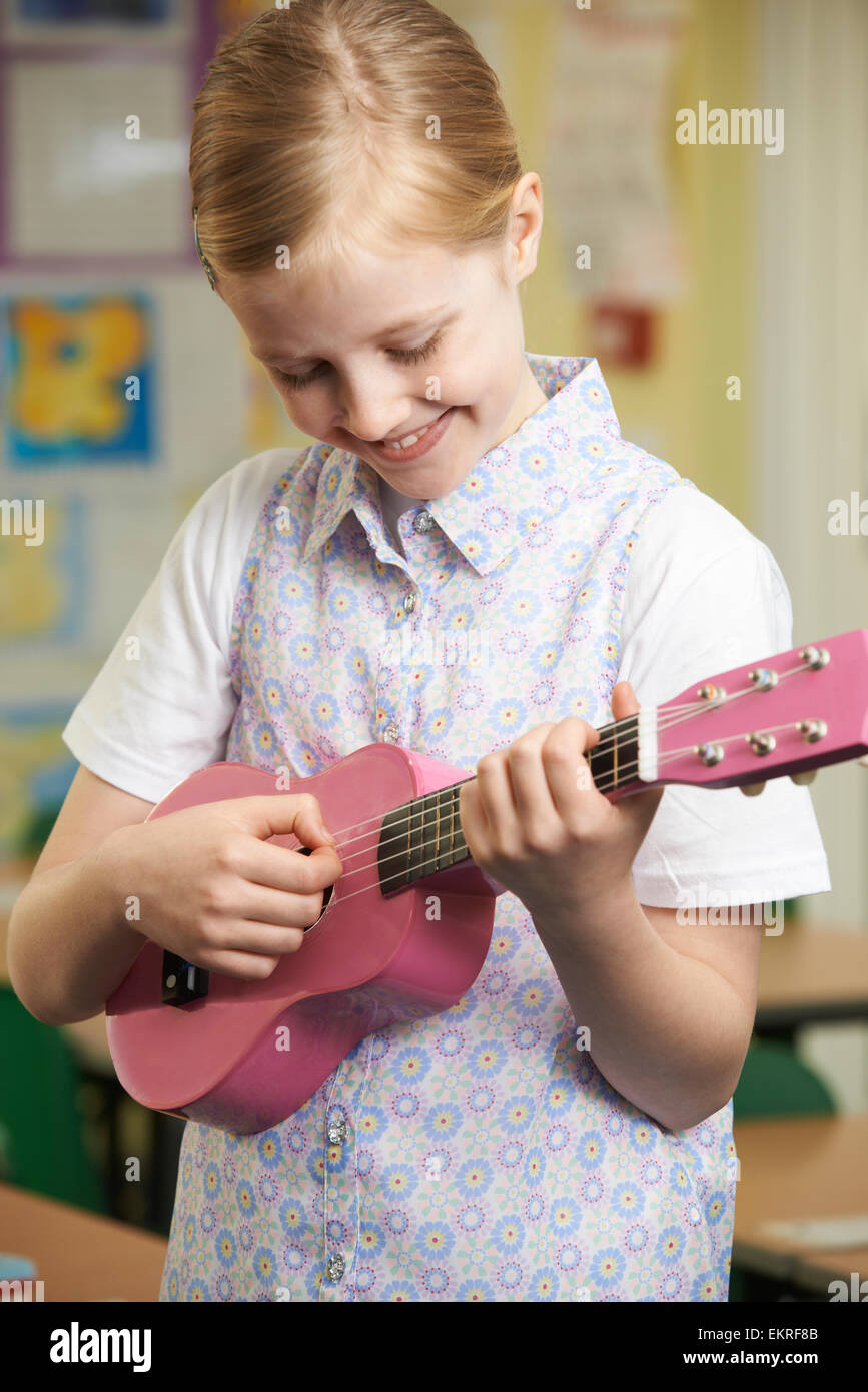 Girl Learning To Play Ukulele In School Music Lesson Stock Photo Alamy