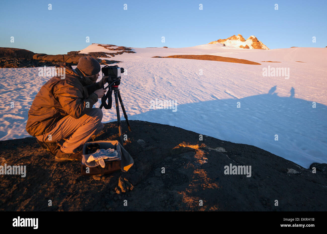 Photographer filming a beautiful mountain landscape at sunrise. Patagonia Argentina Stock Photo