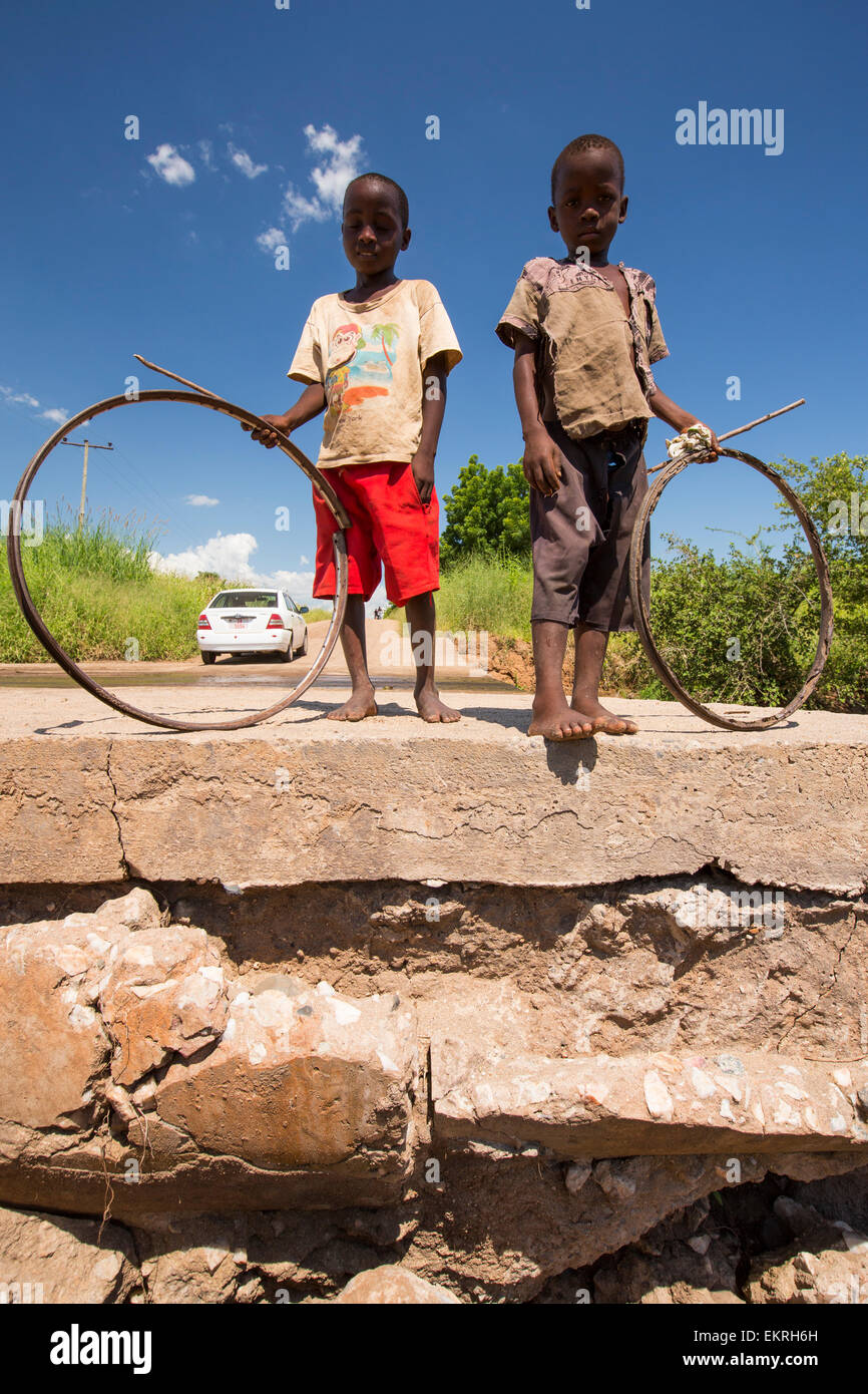 In mid January 2015, a three day period of excessive rain brought unprecedented floods to the small poor African country of Malawi. It displaced nearly quarter of a million people, devastated 64,000 hectares of land, and killed several hundred people. This shot shows one of the may bridges damaged or destroyed around Chikwawa in the Shire Valley. Stock Photo