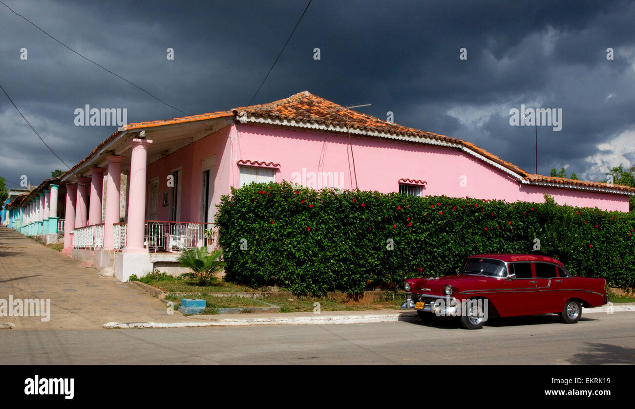 Dark skies with colourful houses and a classic car in Vinales,Cuba Stock Photo