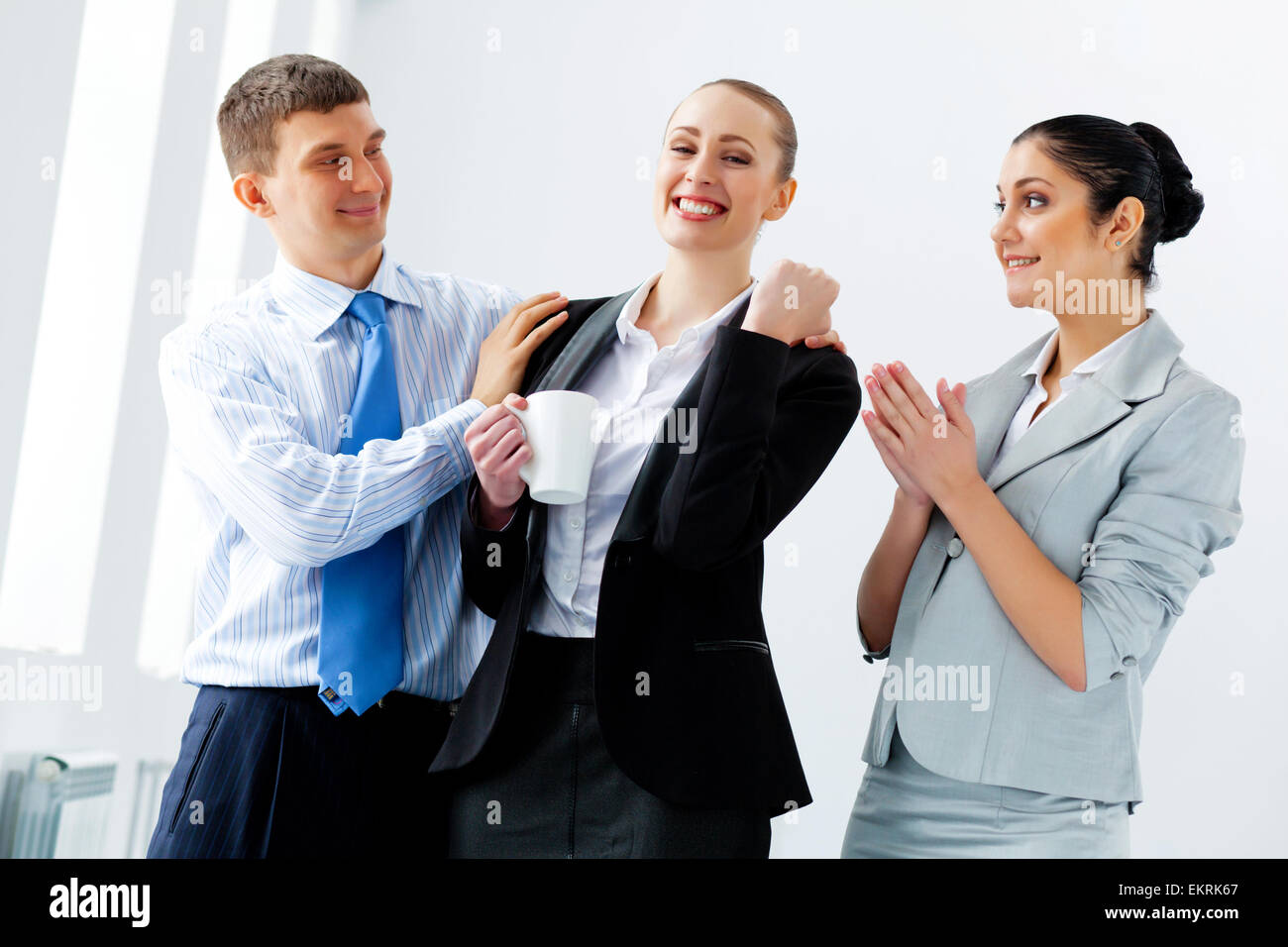 Three young business people laughing Stock Photo - Alamy
