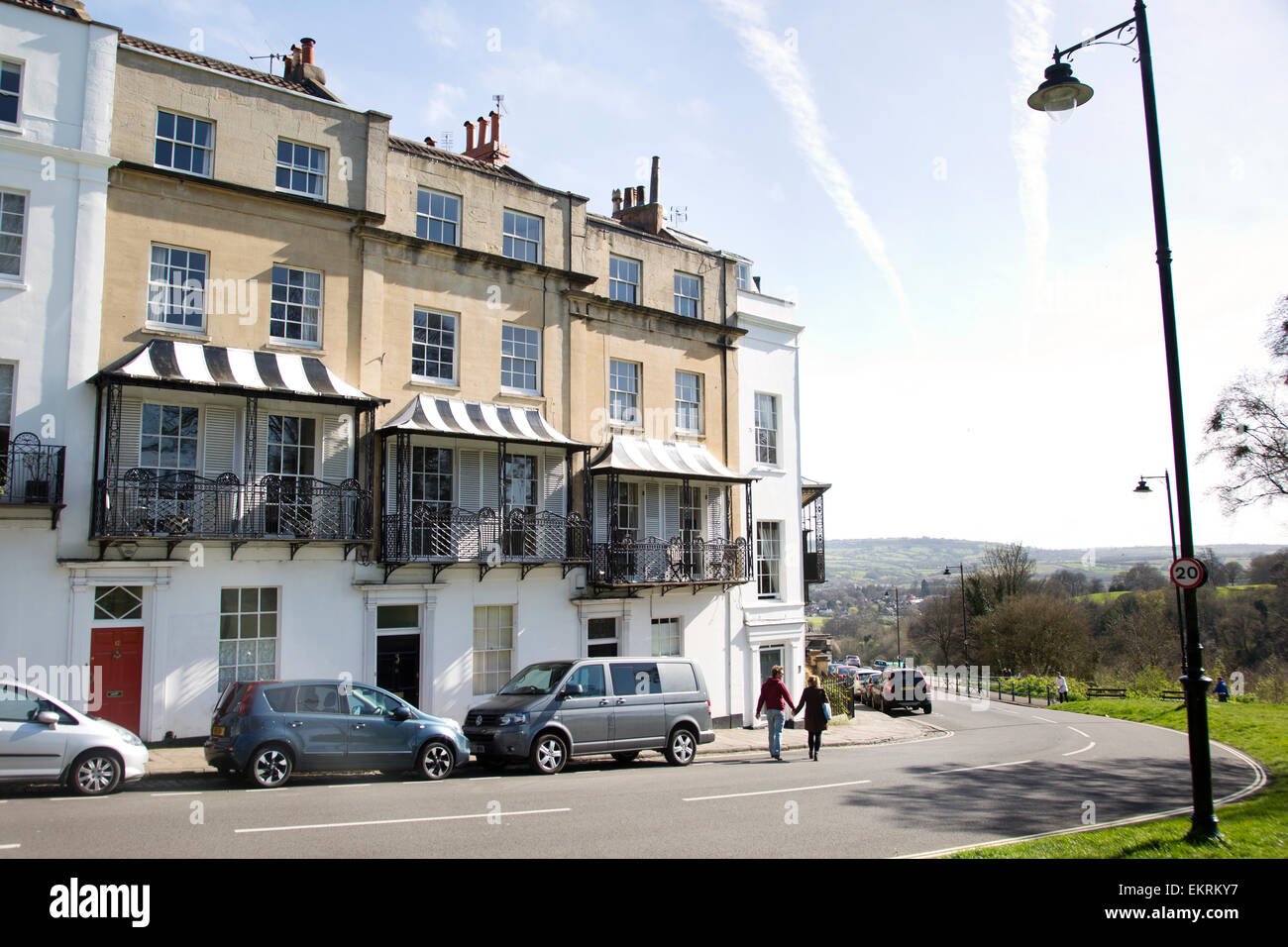 Stripped balconies in Clifton, Bristol with couple walking holding hands. Stock Photo