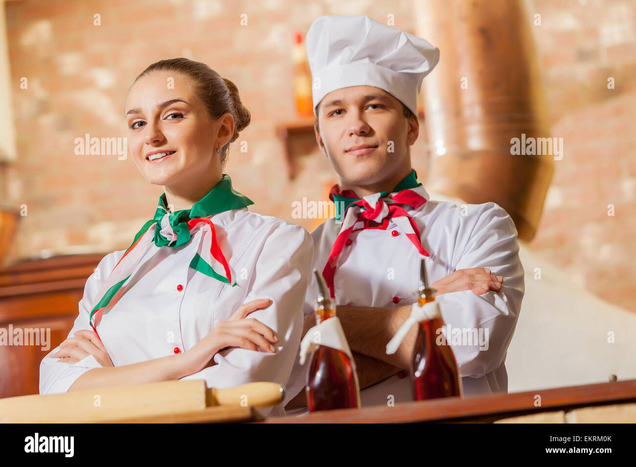 Portrait of two cooks with crossed arms Stock Photo - Alamy