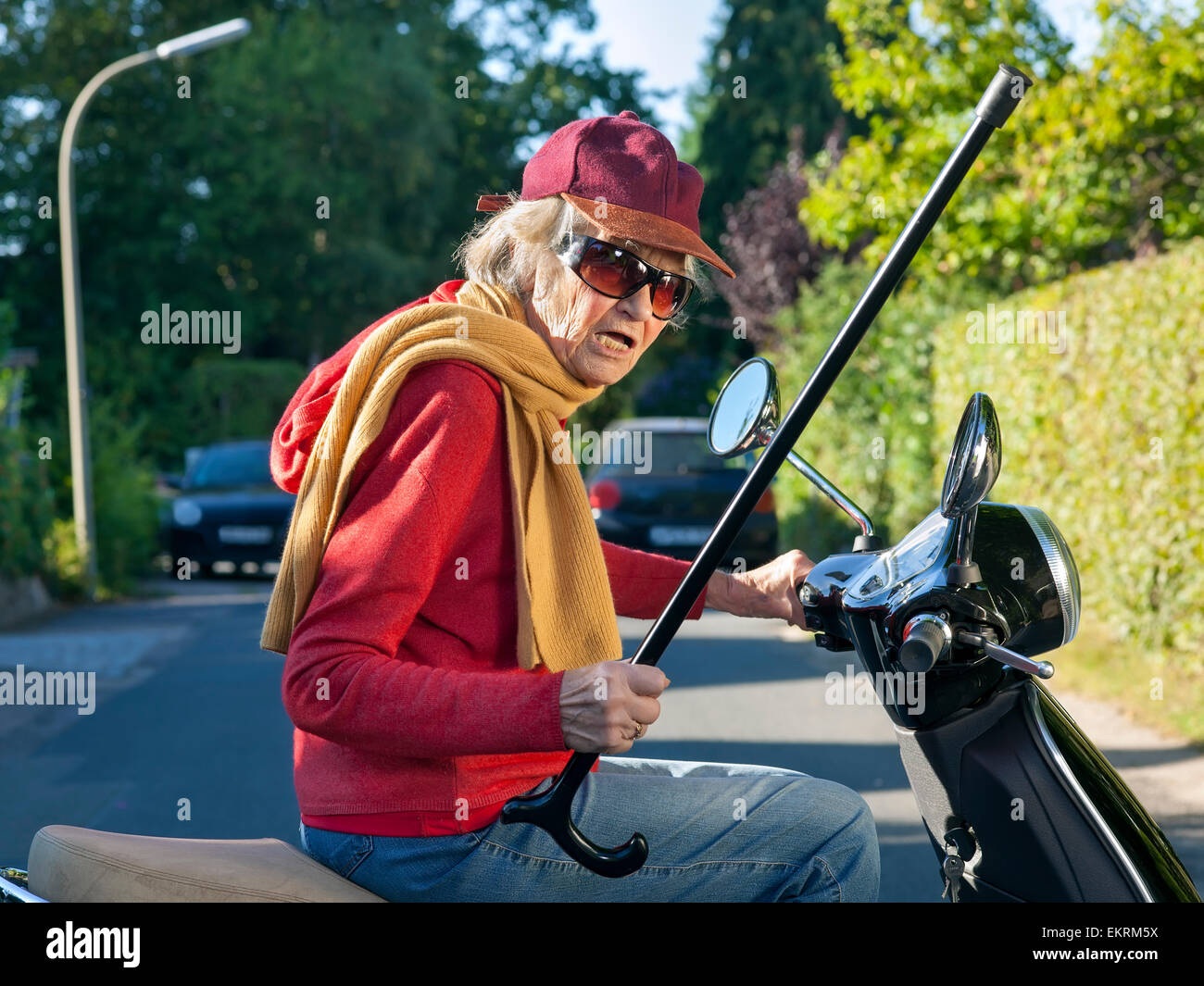 Handsome Man Wearing Sunglasses Riding On Scooter In Summer City. Front  View. Happy Young Guy In Cool Glasses. Concept Of Lifestyle Idea.  Interesting Adventure. Best Vacation In Big Sunny City. Stock Photo,