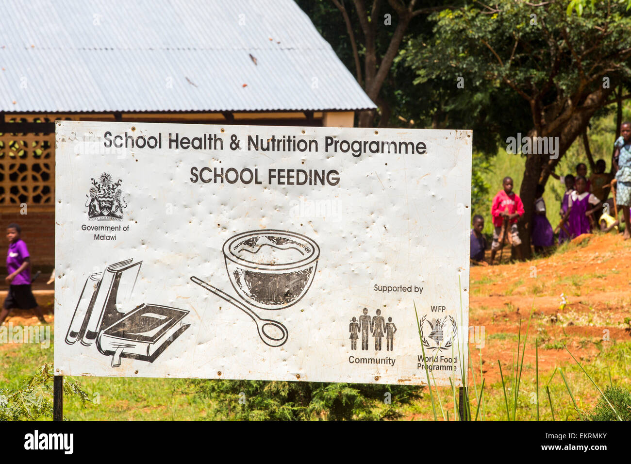 A school feeding program sign at a school on the Zomba Plateau, in a country where malnutrition is common, this World Food Program to provide additional food to infant school pupils is very important. Stock Photo
