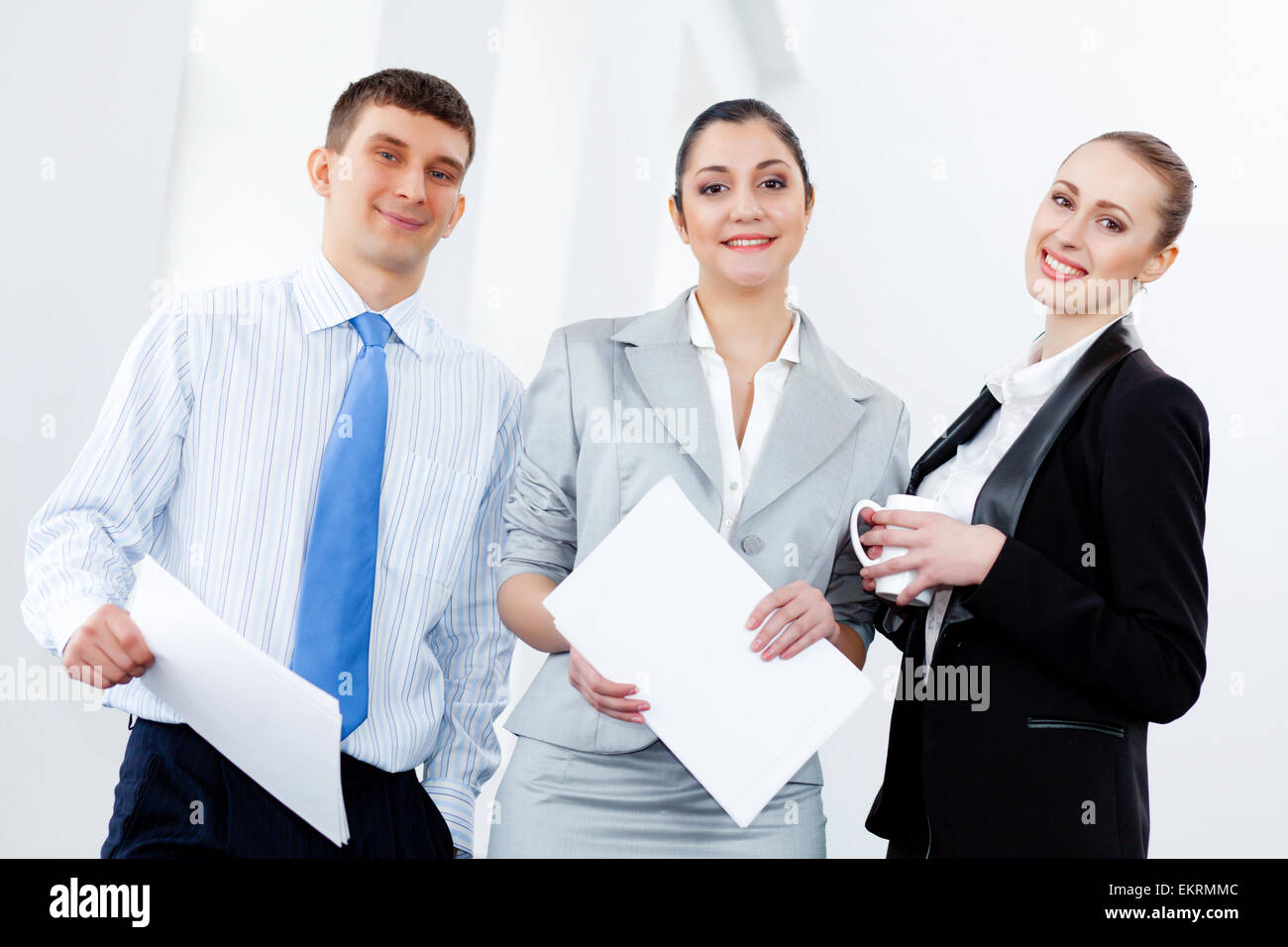 Three young business people laughing Stock Photo - Alamy