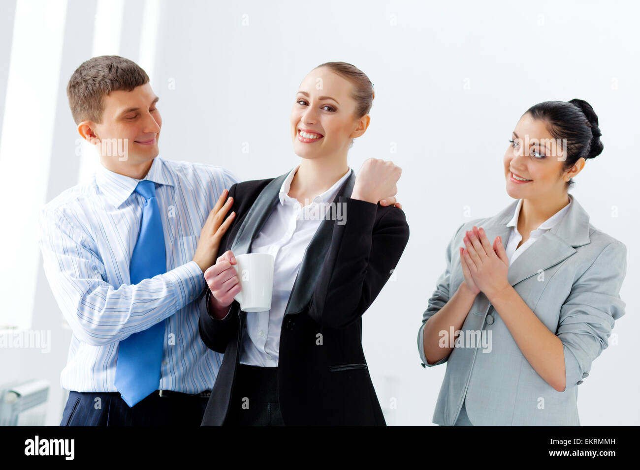 Three young business people laughing Stock Photo - Alamy
