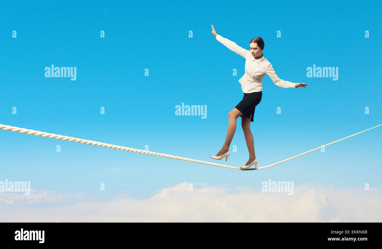 Businesswoman balancing on rope Stock Photo - Alamy