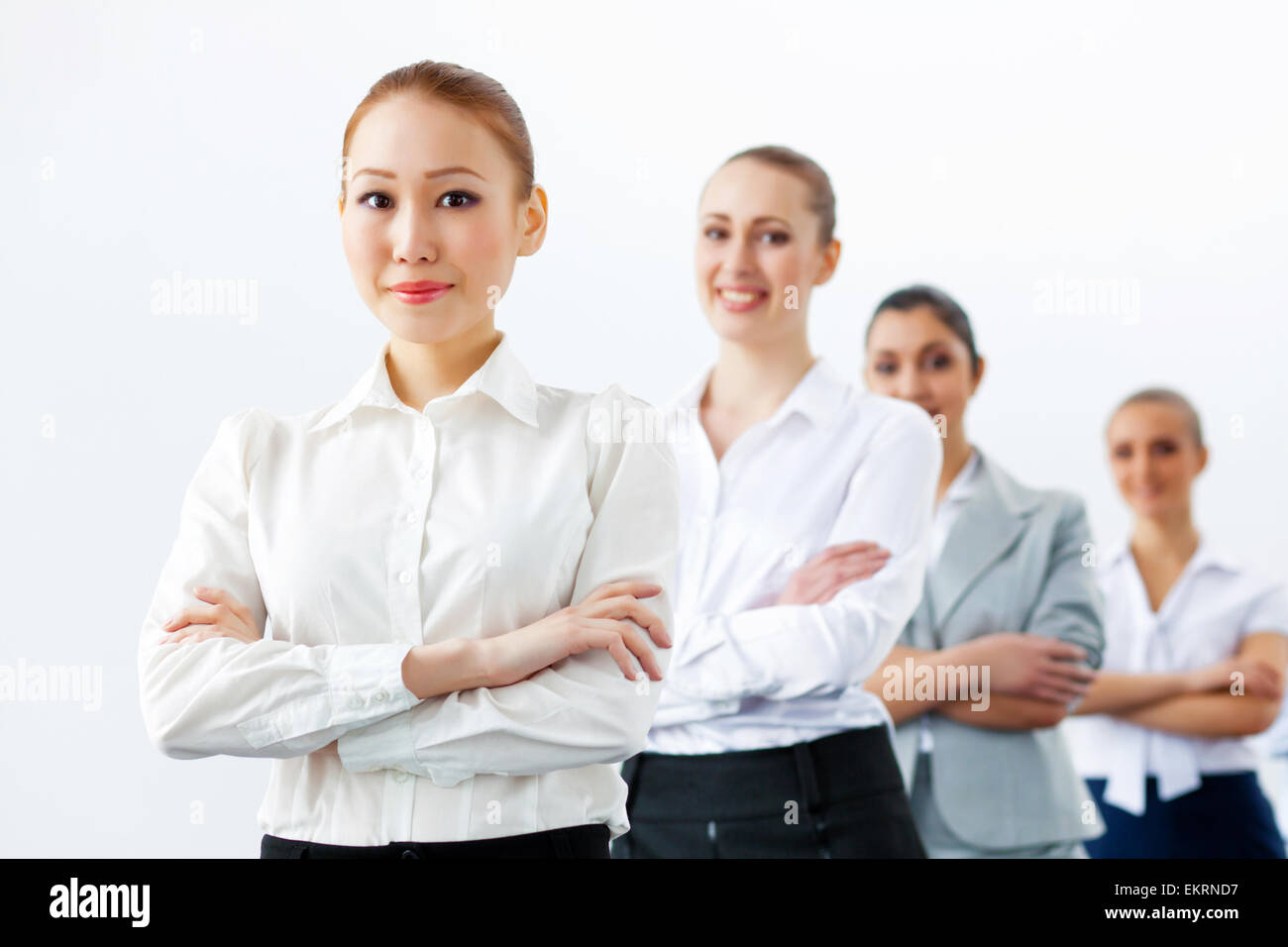 Four businesswomen standing in row Stock Photo - Alamy