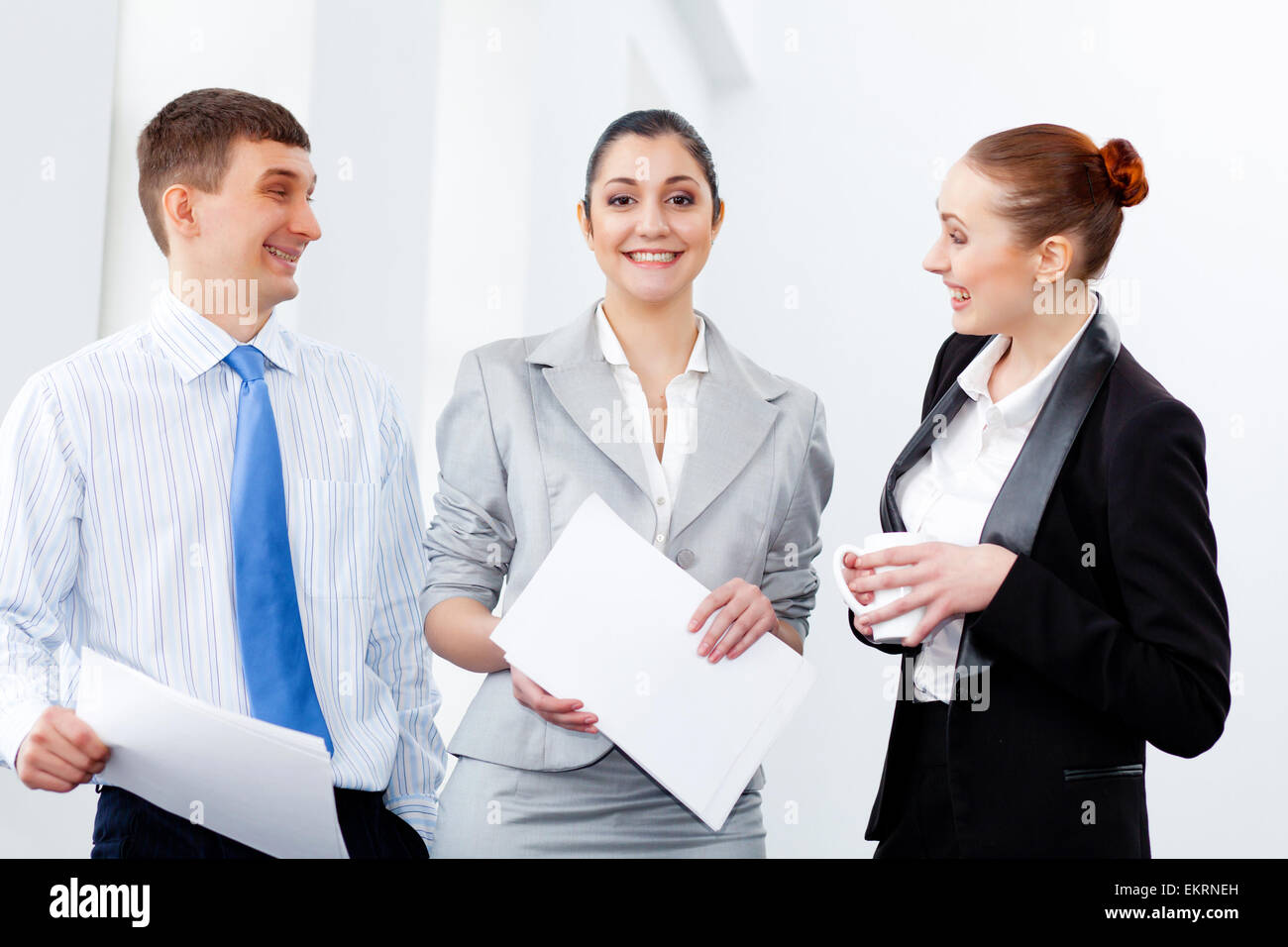 Three young business people laughing Stock Photo - Alamy