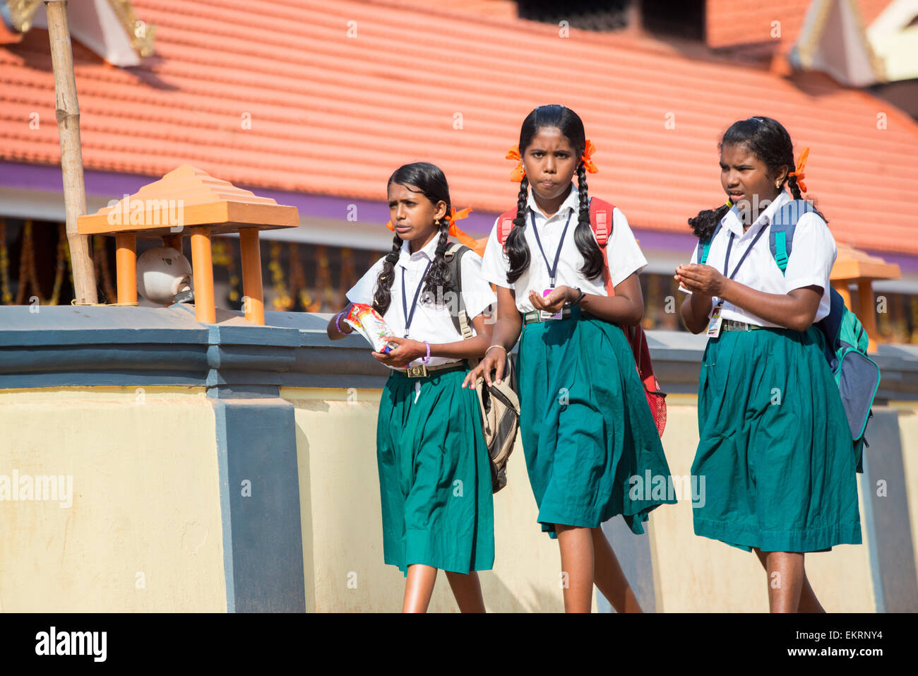 Girls on their way to school alongside the banks of the Backwaters of Kumarakom, Kerala India Stock Photo