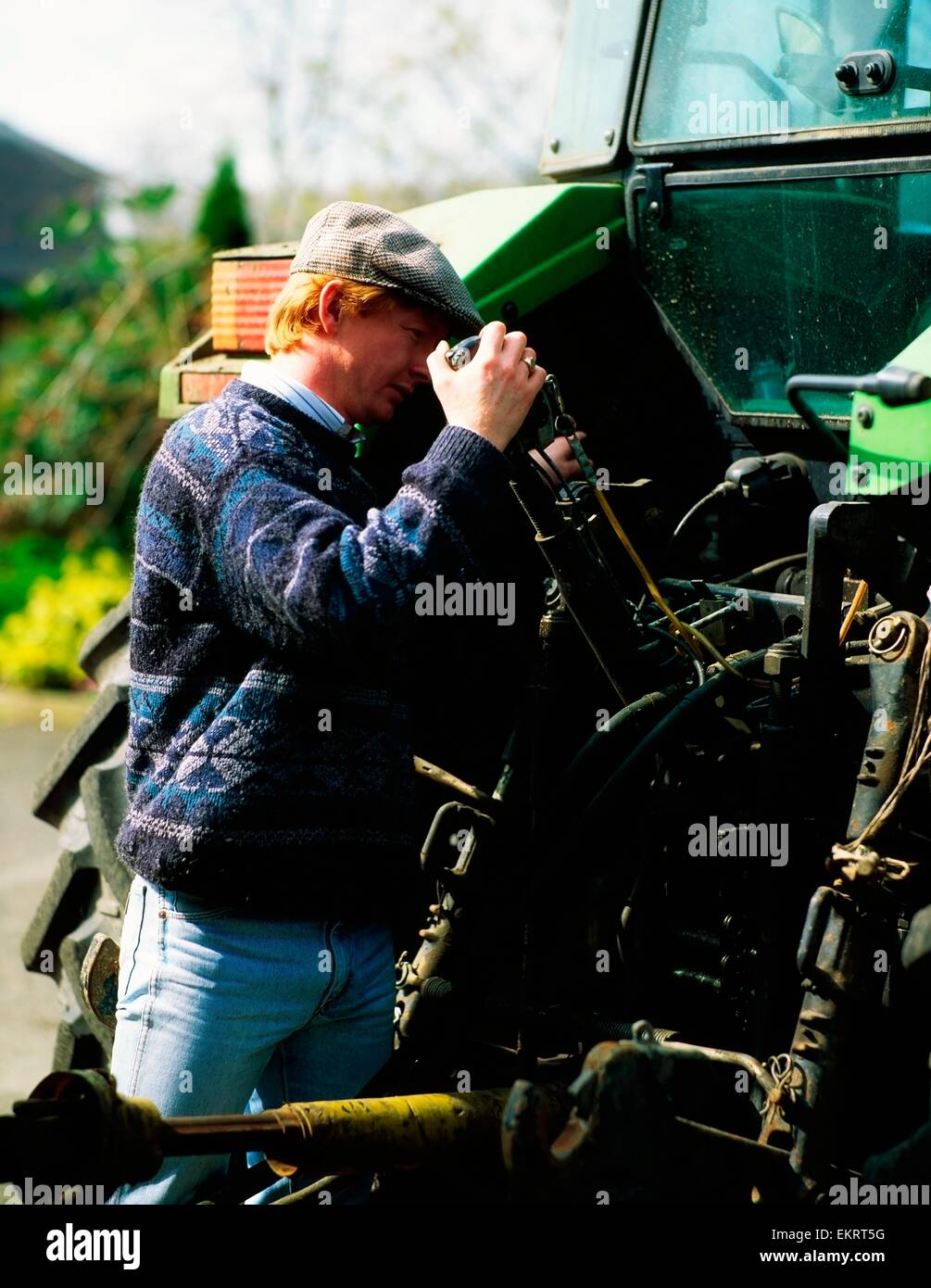 Farmer Repairing A Tractor, Ireland Stock Photo Alamy