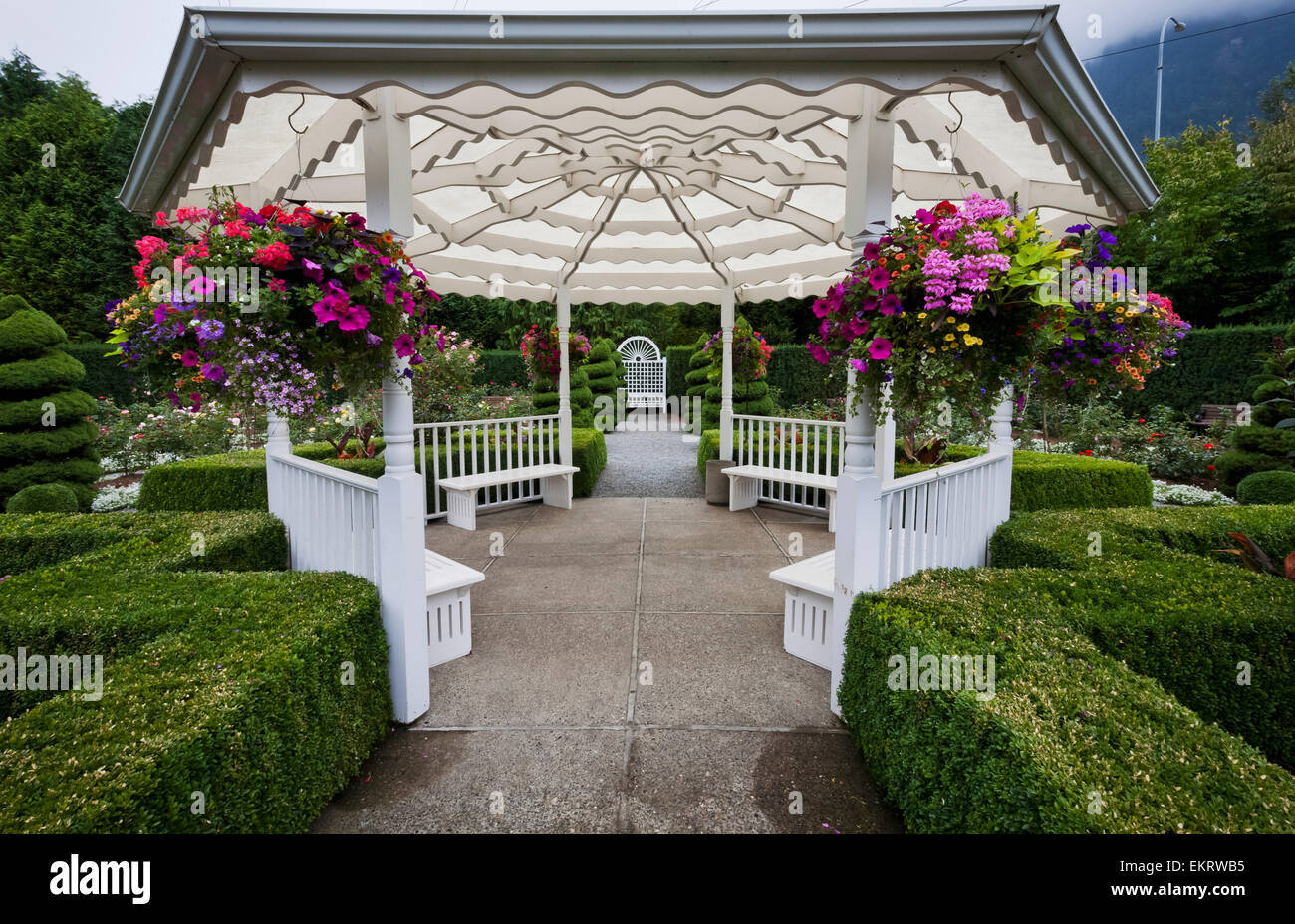 White gazebo with hanging flower baskets in Minter Gardens; Rosedale