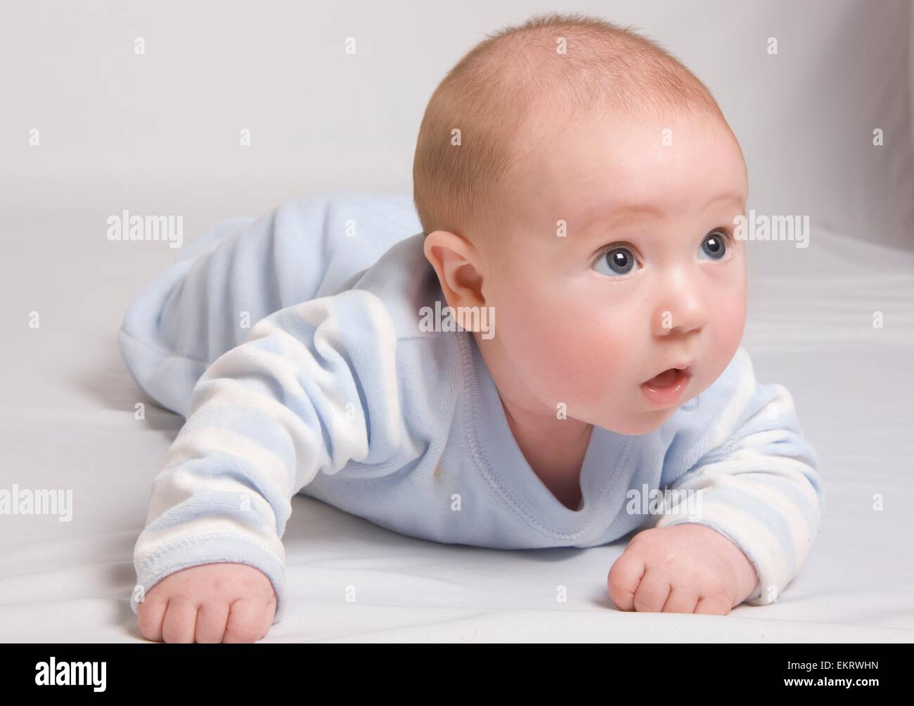 Baby In Onesie Crawling Stock Photo Alamy