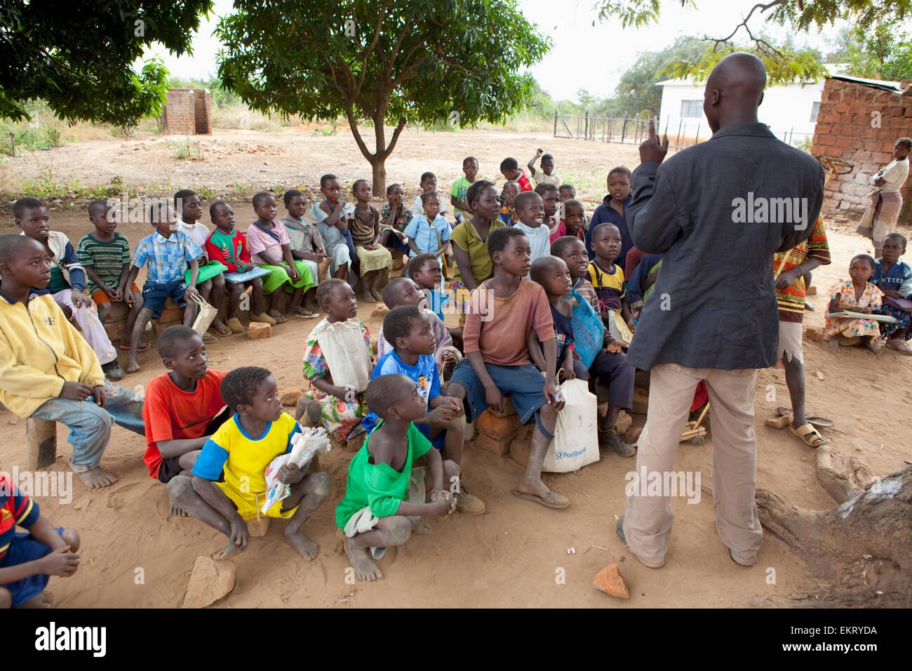 An Outdoor School Classroom With A Male Teacher; Manica, Mozambique, Africa Stock Photo